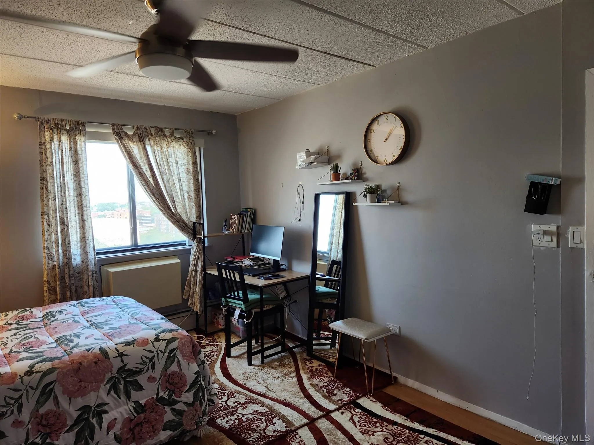 Bedroom with multiple windows, wood finished floors, a desk, and ceiling fan Bedroom with multiple windows, wood finished floors, a desk, and ceiling fan