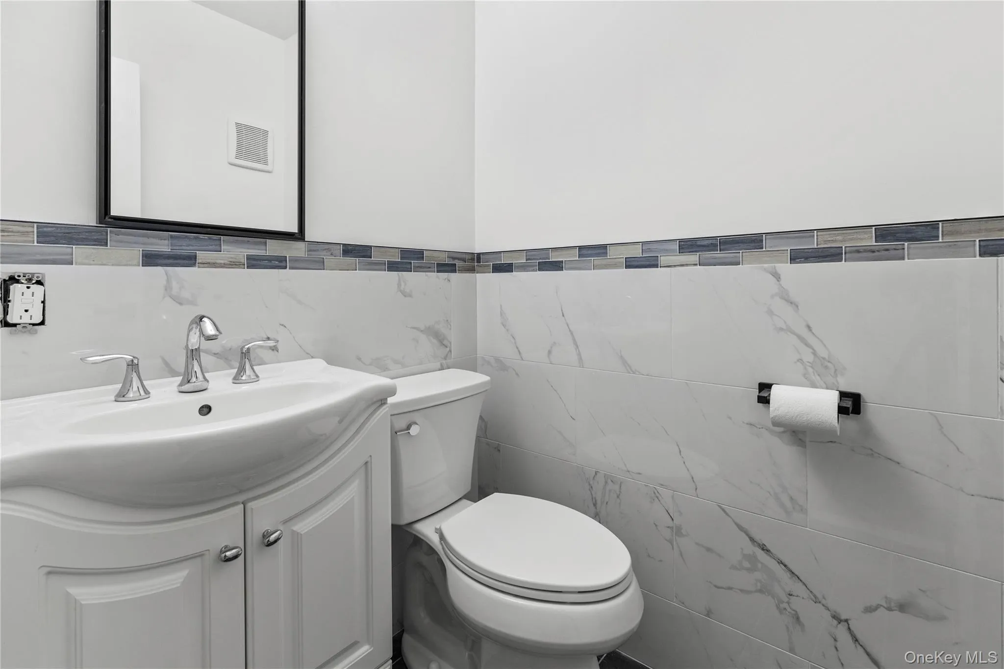 1/2 bath with vanity and tile walls 1/2 bath with vanity and tile walls