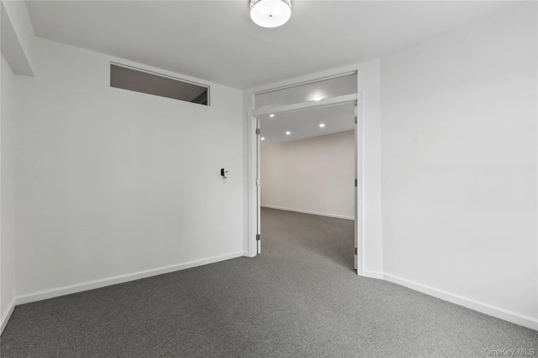 Carpeted spare room with baseboards Carpeted spare room with baseboards