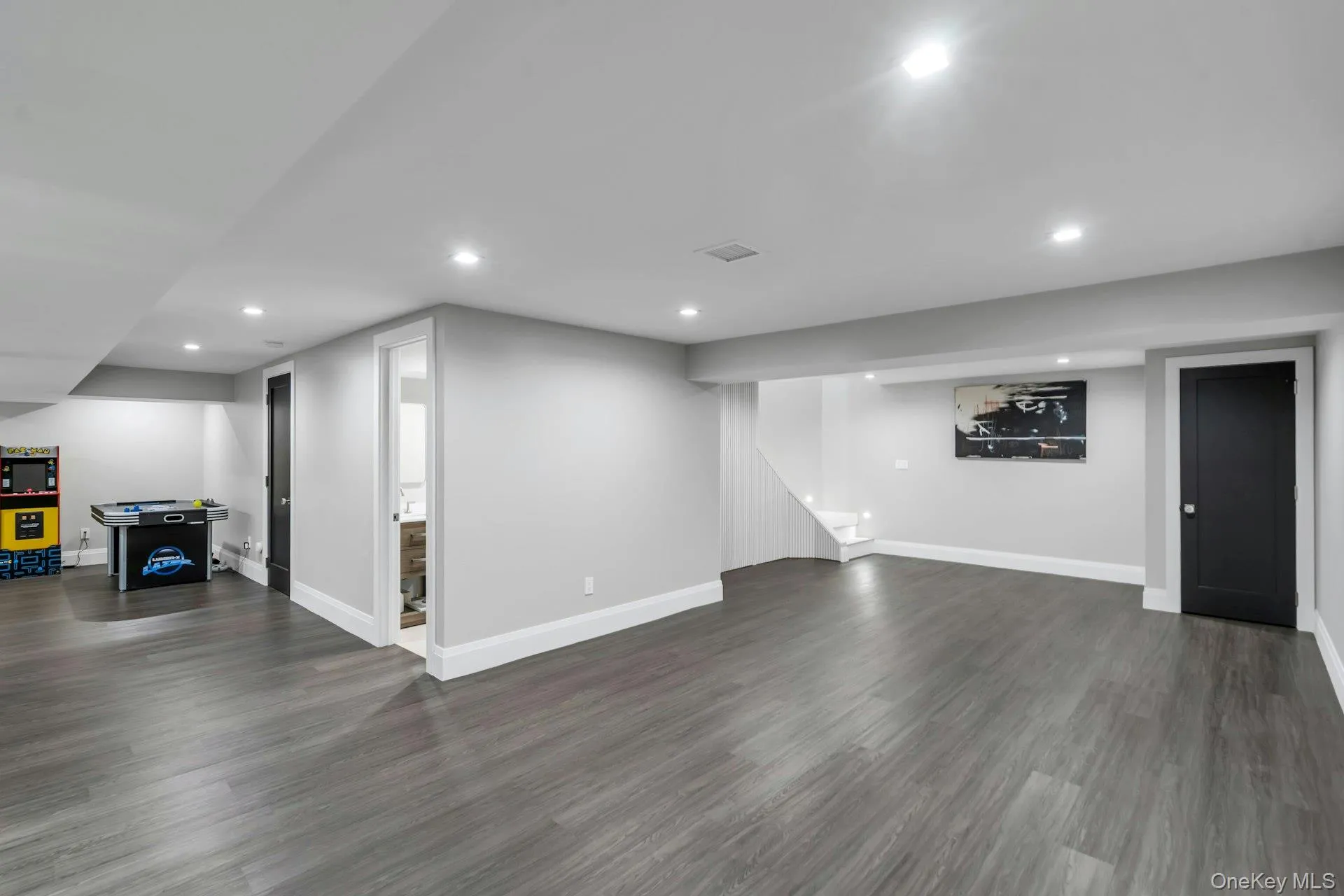 Finished basement featuring recessed lighting and dark wood-type flooring Finished basement featuring recessed lighting and dark wood-type flooring