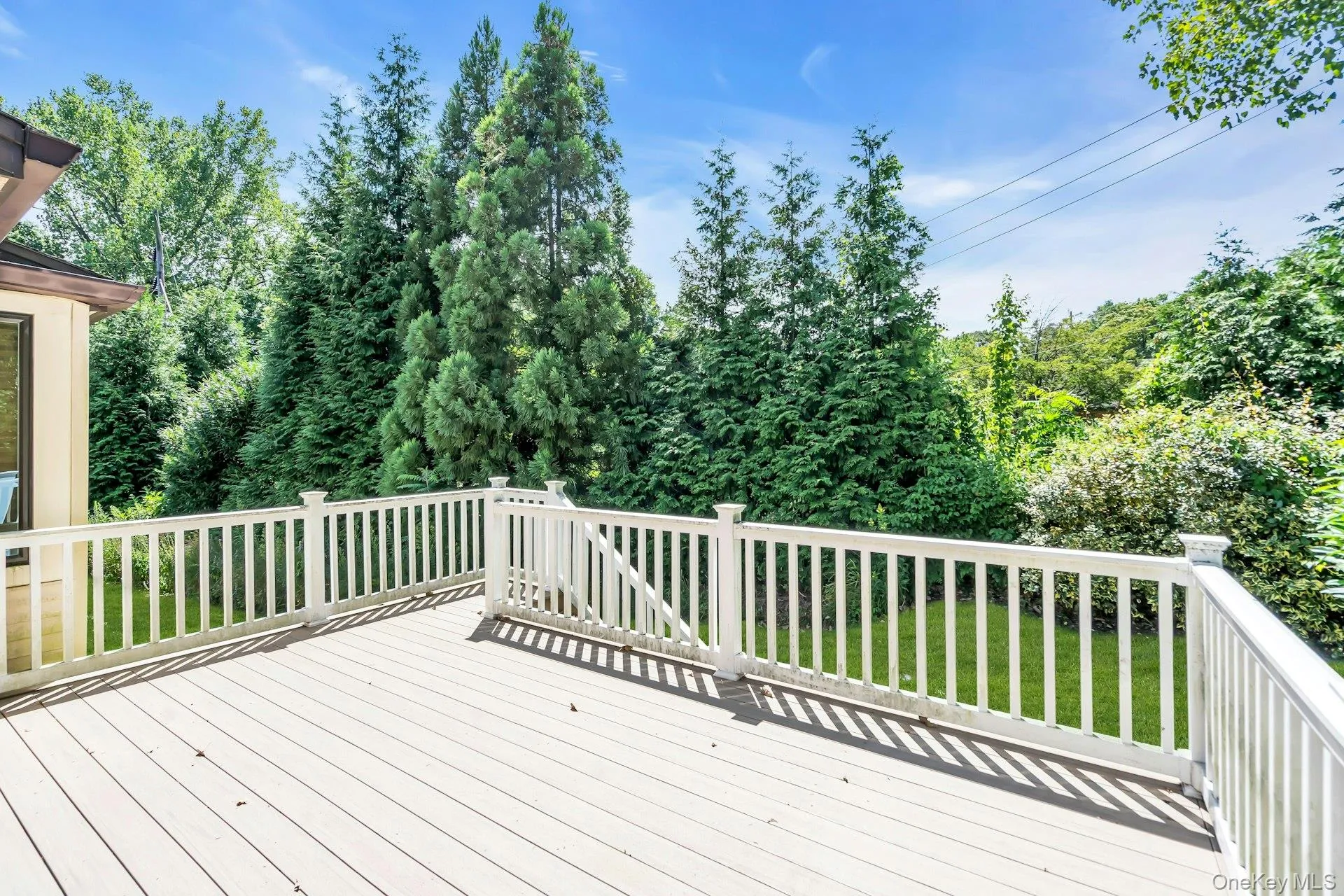 Back Wooden terrace featuring a lawn Back Wooden terrace featuring a lawn