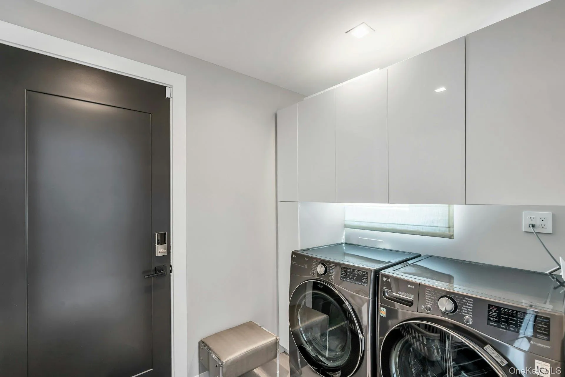 Laundry area with washer and dryer and cabinet space, exit to gararge Laundry area with washer and dryer and cabinet space, exit to gararge