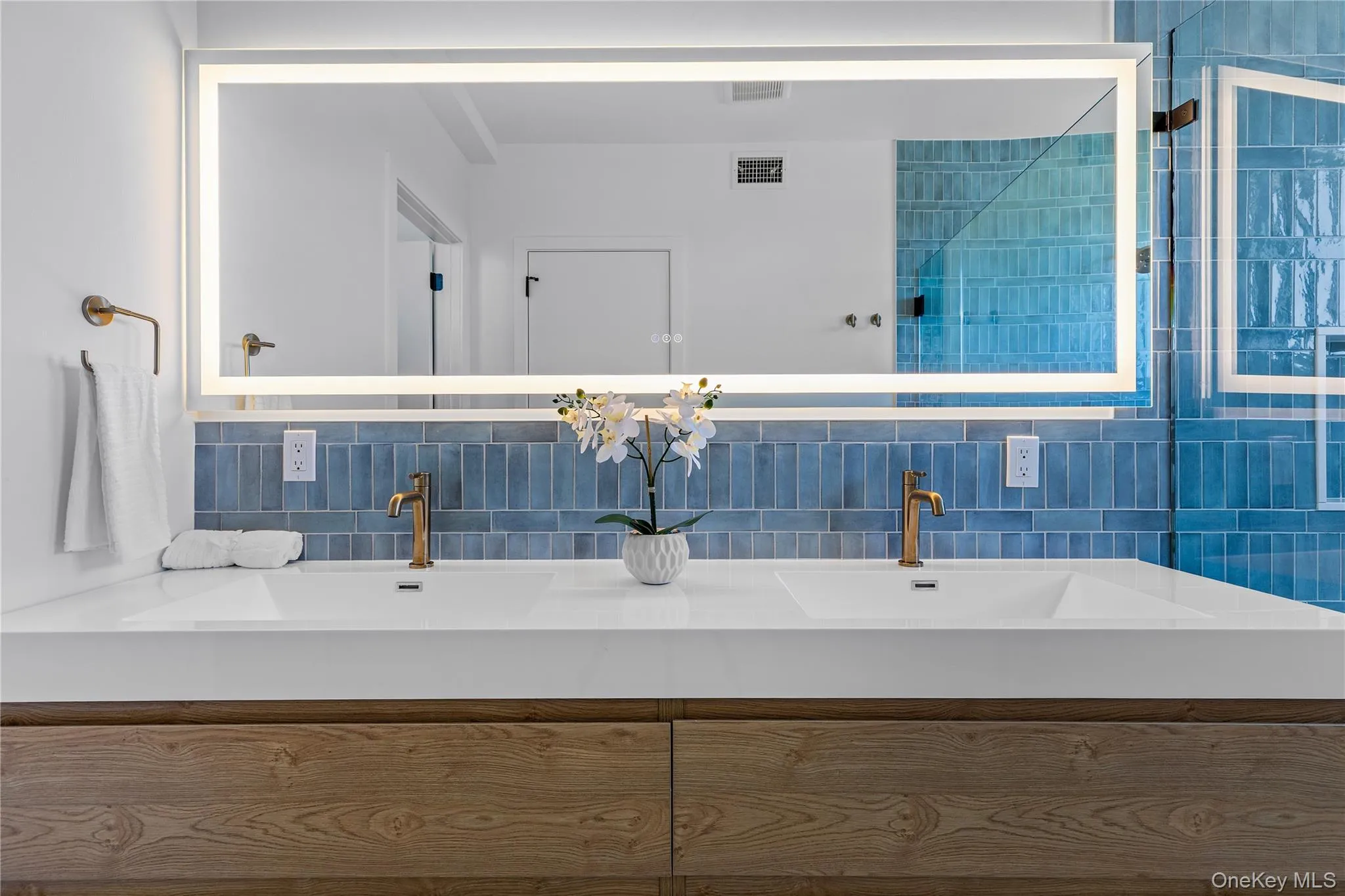 Full bath featuring tasteful backsplash and double vanity Full bath featuring tasteful backsplash and double vanity
