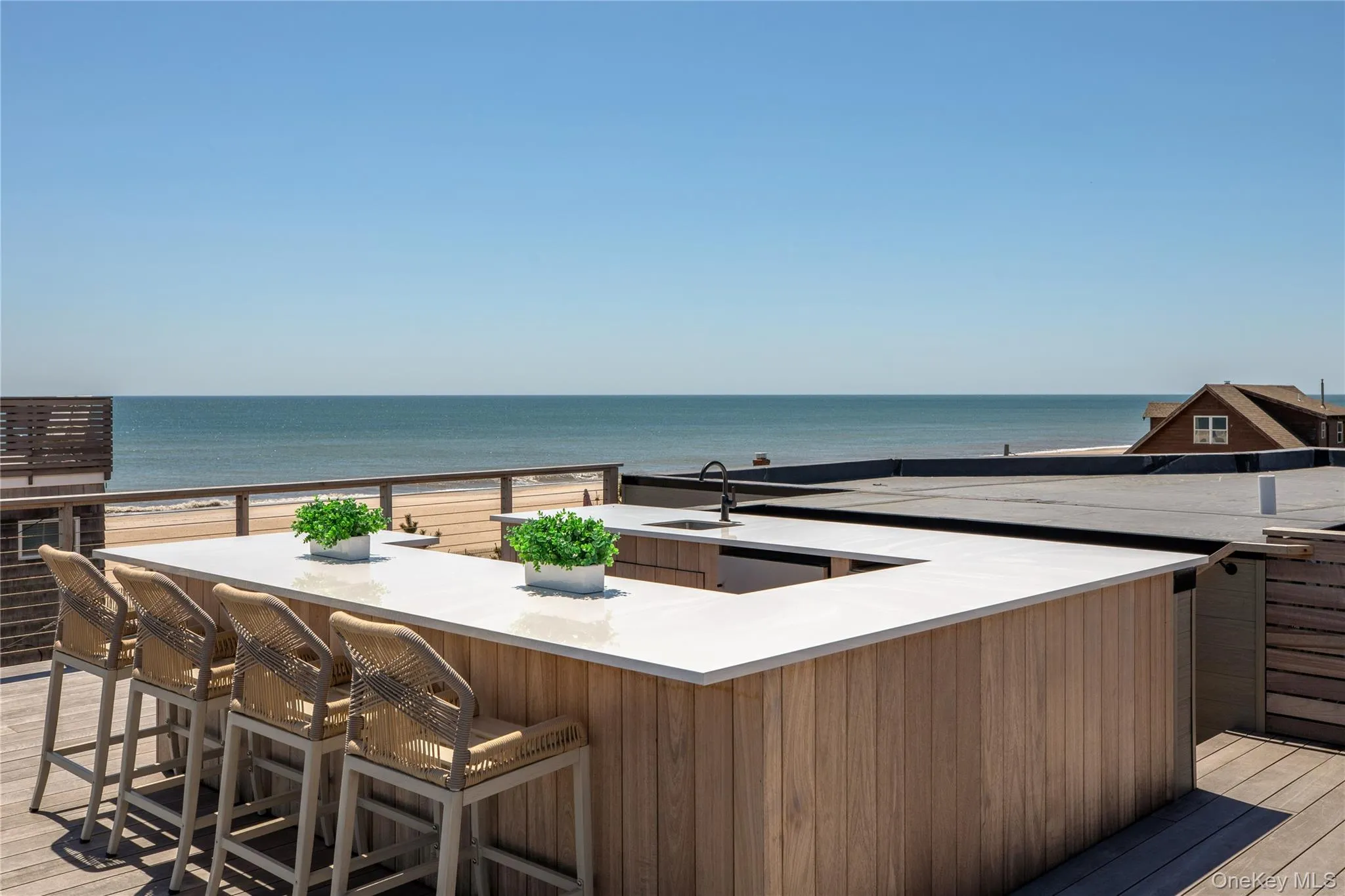 Wooden terrace with a water view and a sink Wooden terrace with a water view and a sink