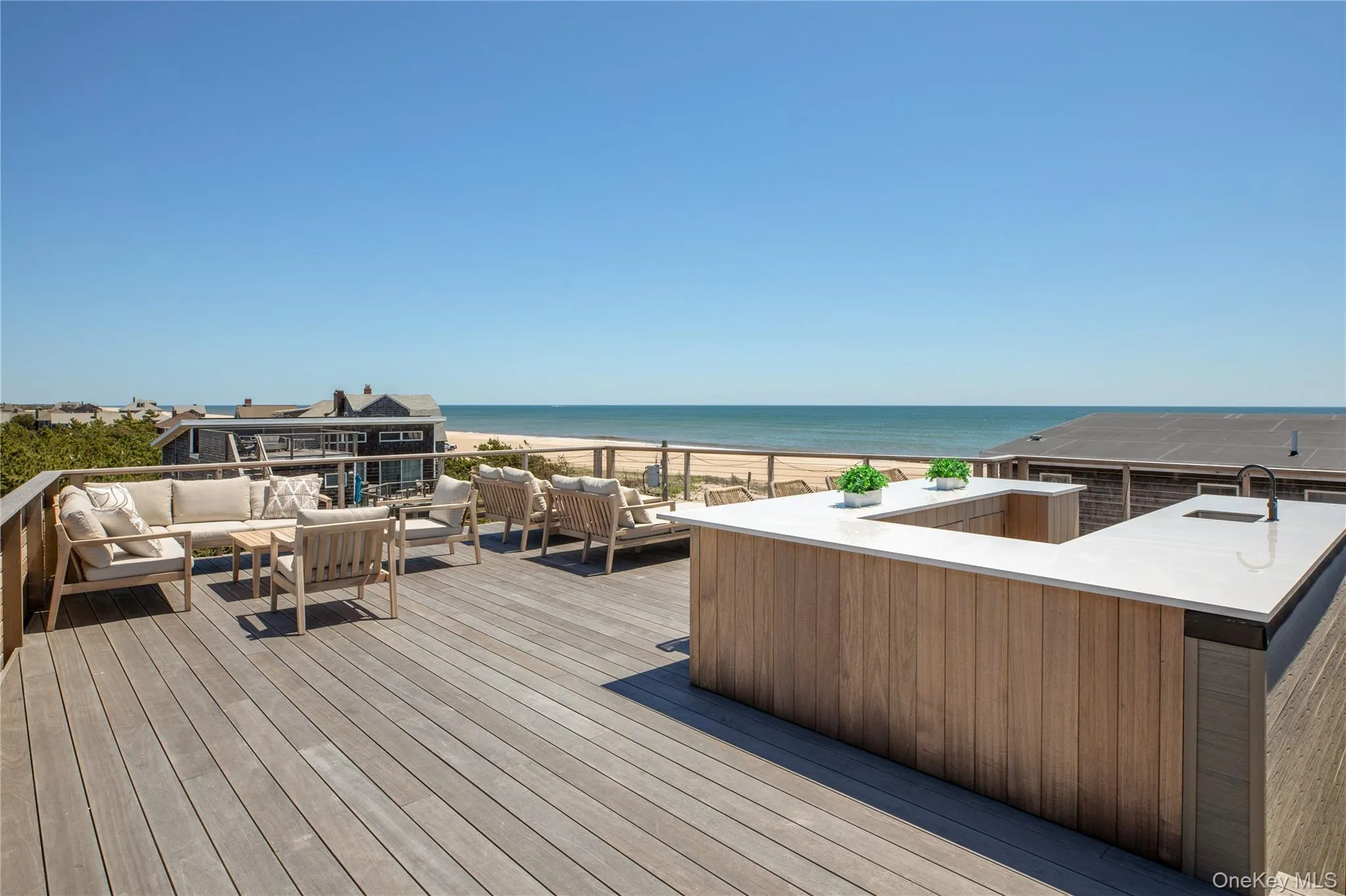 Deck with outdoor lounge area and view of water and beach Deck with outdoor lounge area and view of water and beach