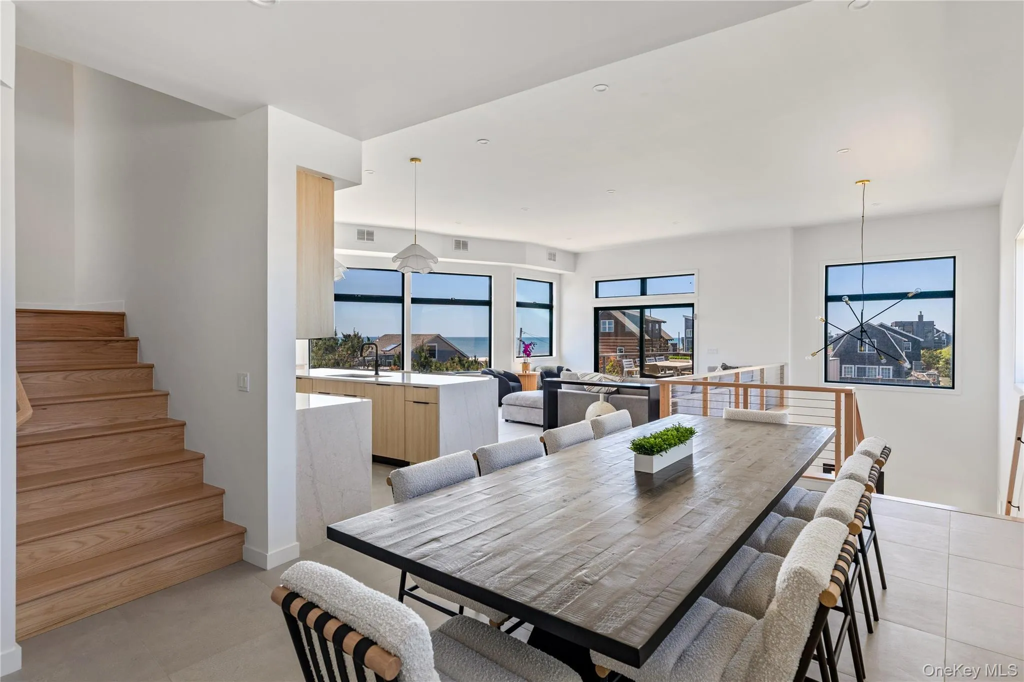 Dining area with plenty of natural light and stairway Dining area with plenty of natural light and stairway
