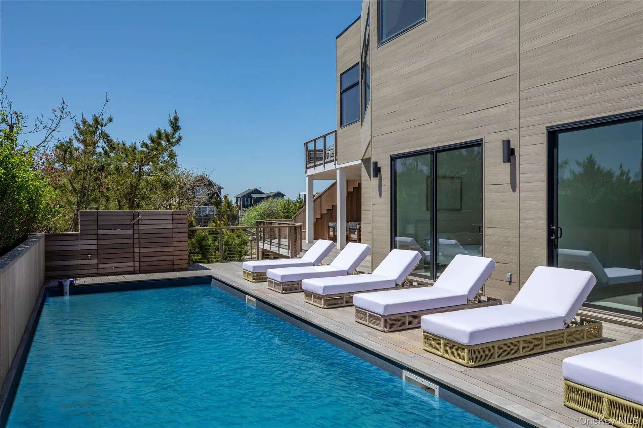 Swimming pool featuring a deck and a balcony Swimming pool featuring a deck and a balcony
