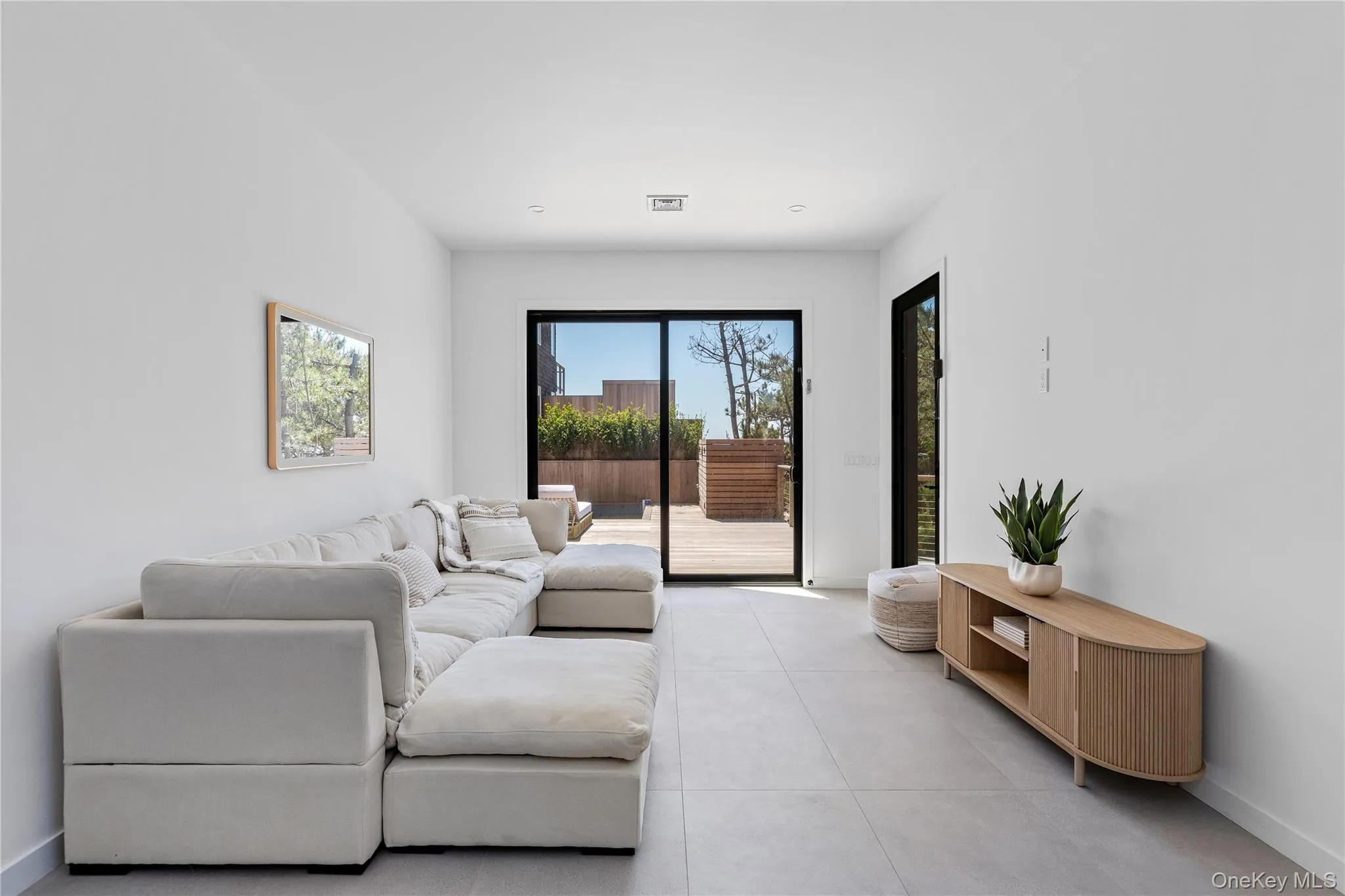 Tiled living room with baseboards and recessed lighting Tiled living room with baseboards and recessed lighting