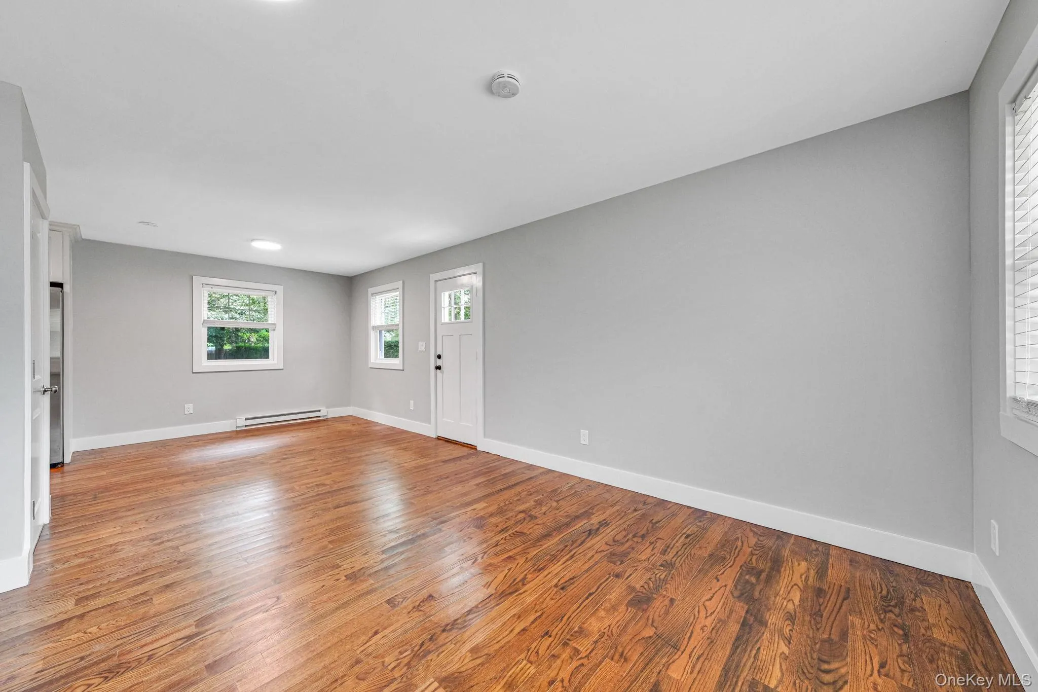 Entryway with light wood-style floors and baseboard heating
