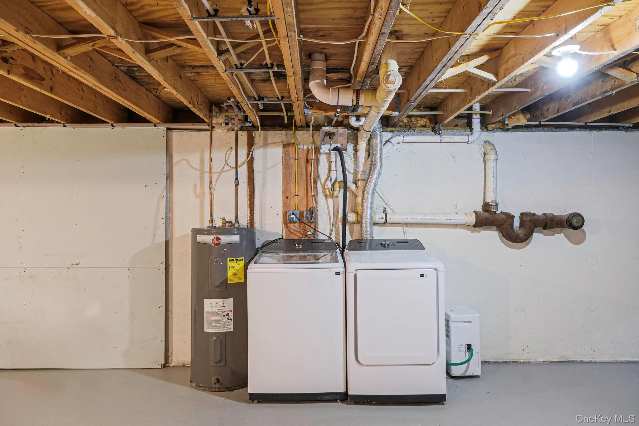 Washroom featuring water heater and independent washer and dryer