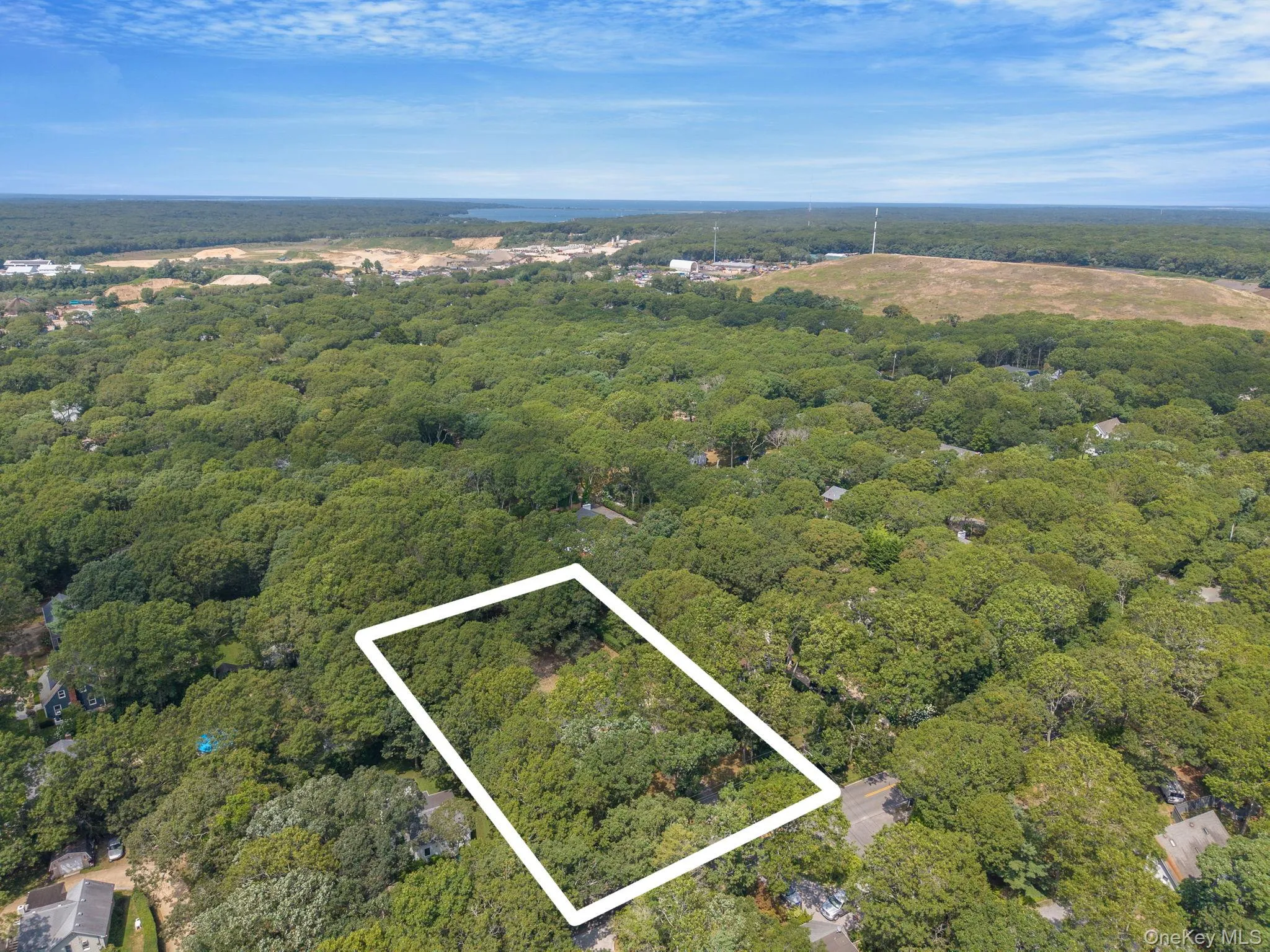 View of property location featuring a heavily wooded area and property parcel outlined