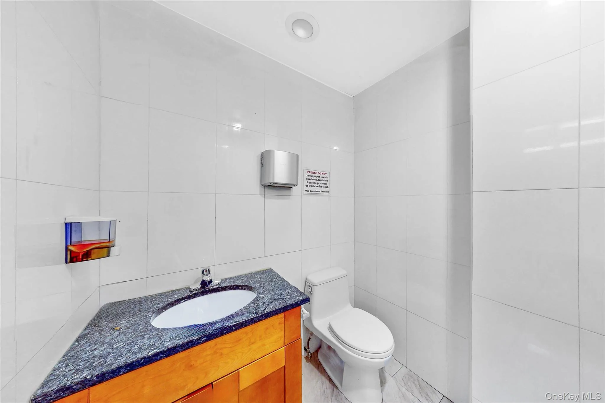 Bathroom with tile walls and vanity Bathroom with tile walls and vanity