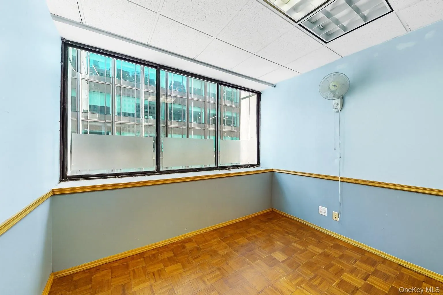 Spare room featuring baseboards and a paneled ceiling Spare room featuring baseboards and a paneled ceiling