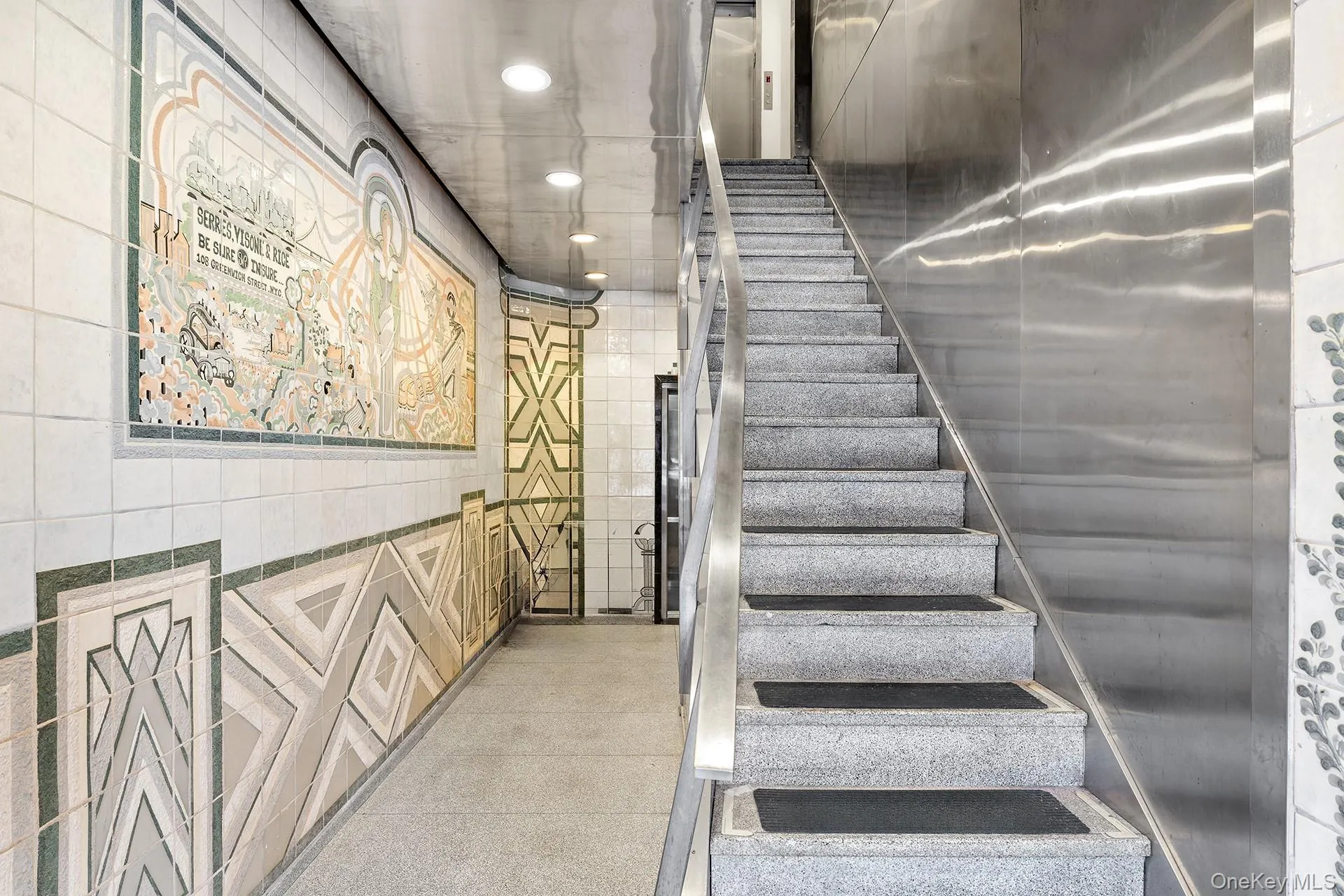 Stairs with tile walls and recessed lighting Stairs with tile walls and recessed lighting