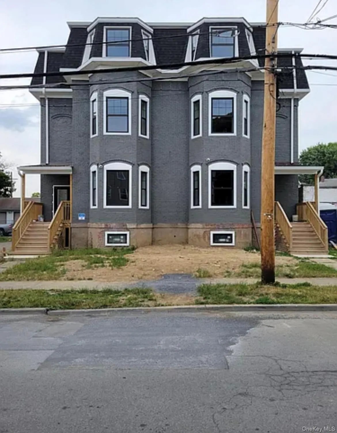 Victorian home with mansard roof and brick siding Victorian home with mansard roof and brick siding