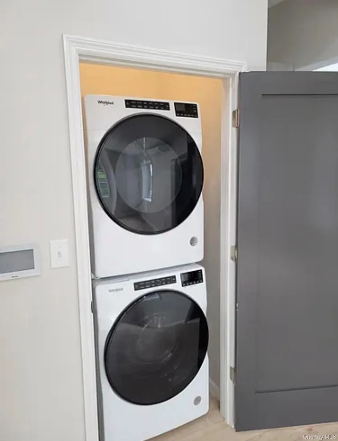 Washroom featuring stacked washing machine and dryer Washroom featuring stacked washing machine and dryer