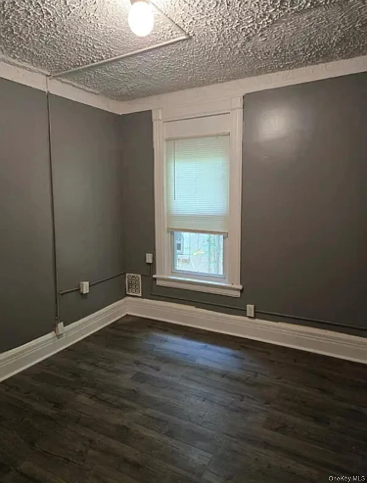 Empty room featuring dark wood finished floors Empty room featuring dark wood finished floors