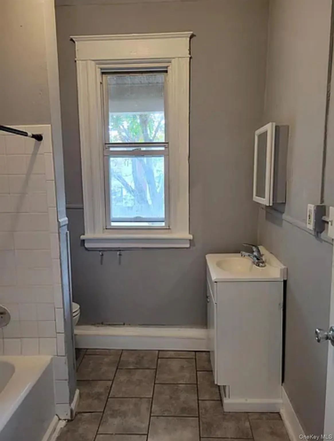 Full bathroom featuring vanity, shower combination, and light tile patterned floors Full bathroom featuring vanity, shower combination, and light tile patterned floors