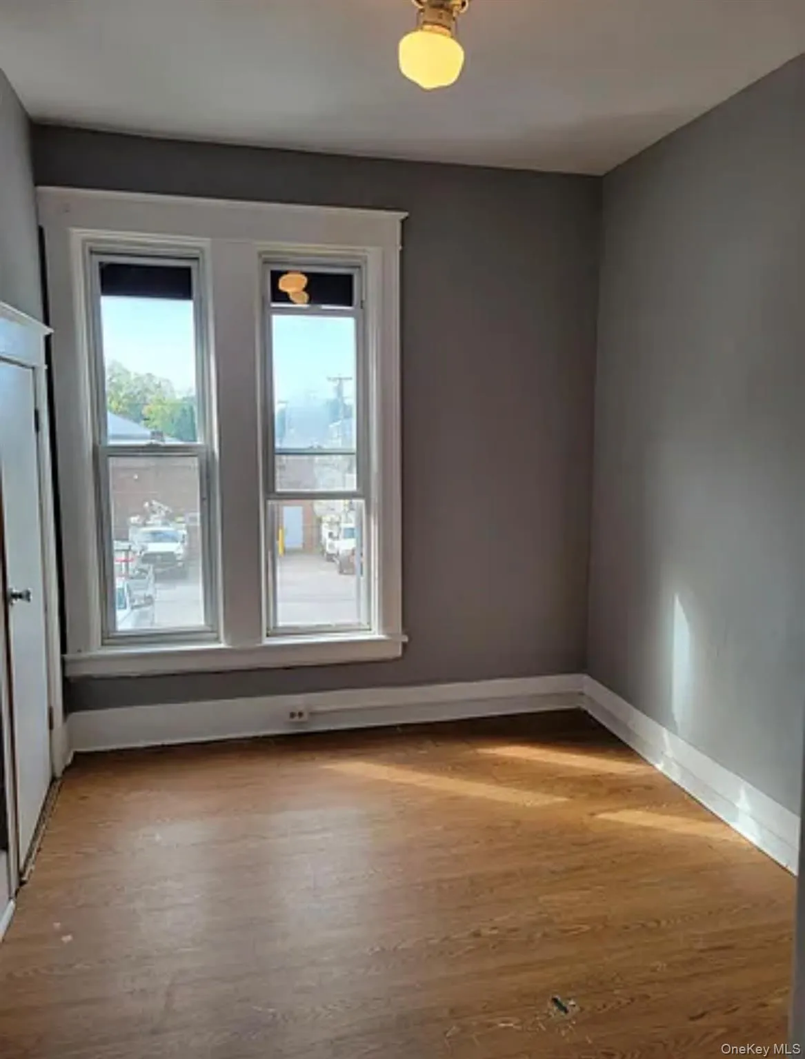 Unfurnished room with baseboards and light wood-type flooring Unfurnished room with baseboards and light wood-type flooring
