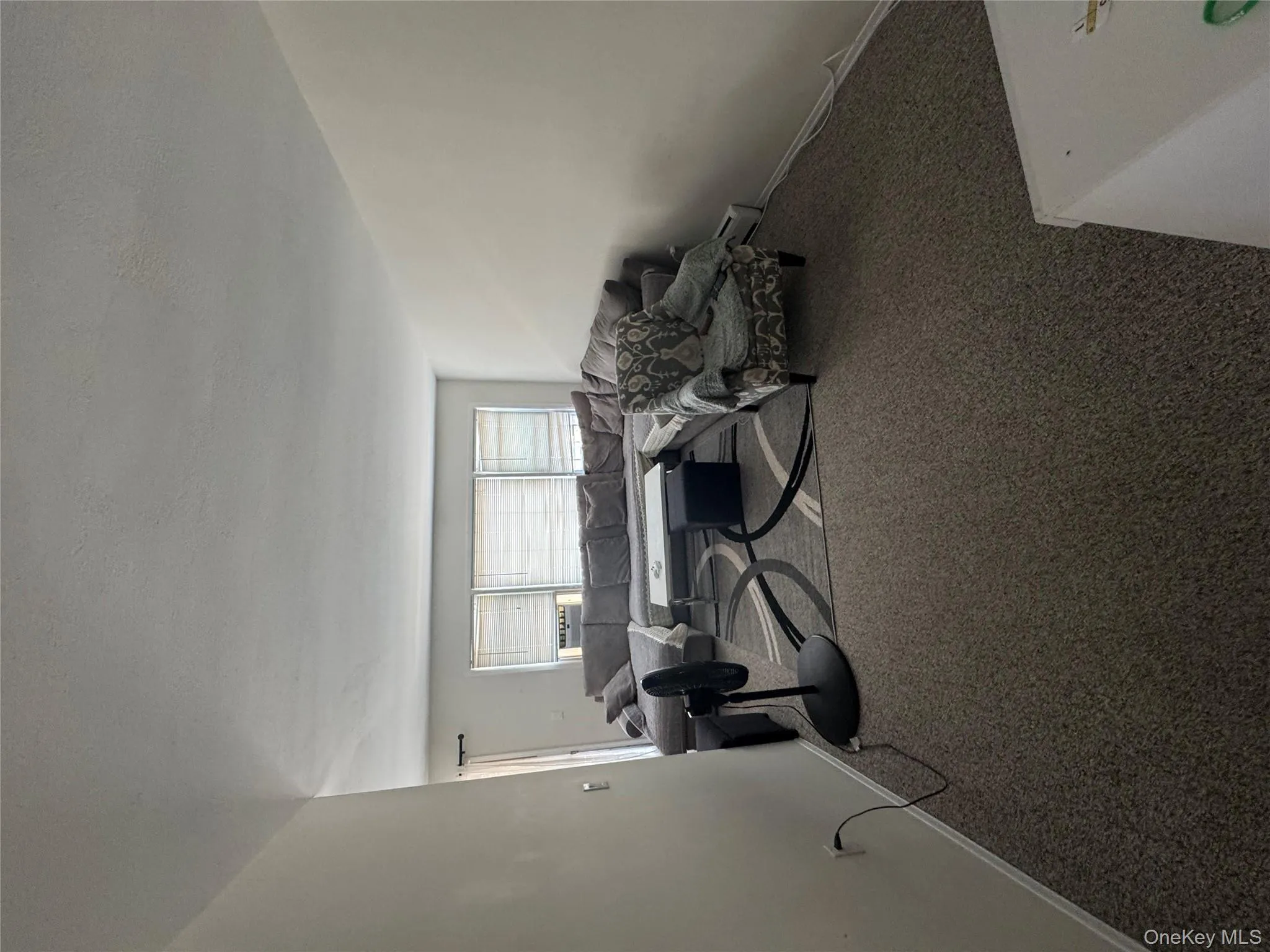 Living area featuring carpet floors and baseboards Living area featuring carpet floors and baseboards