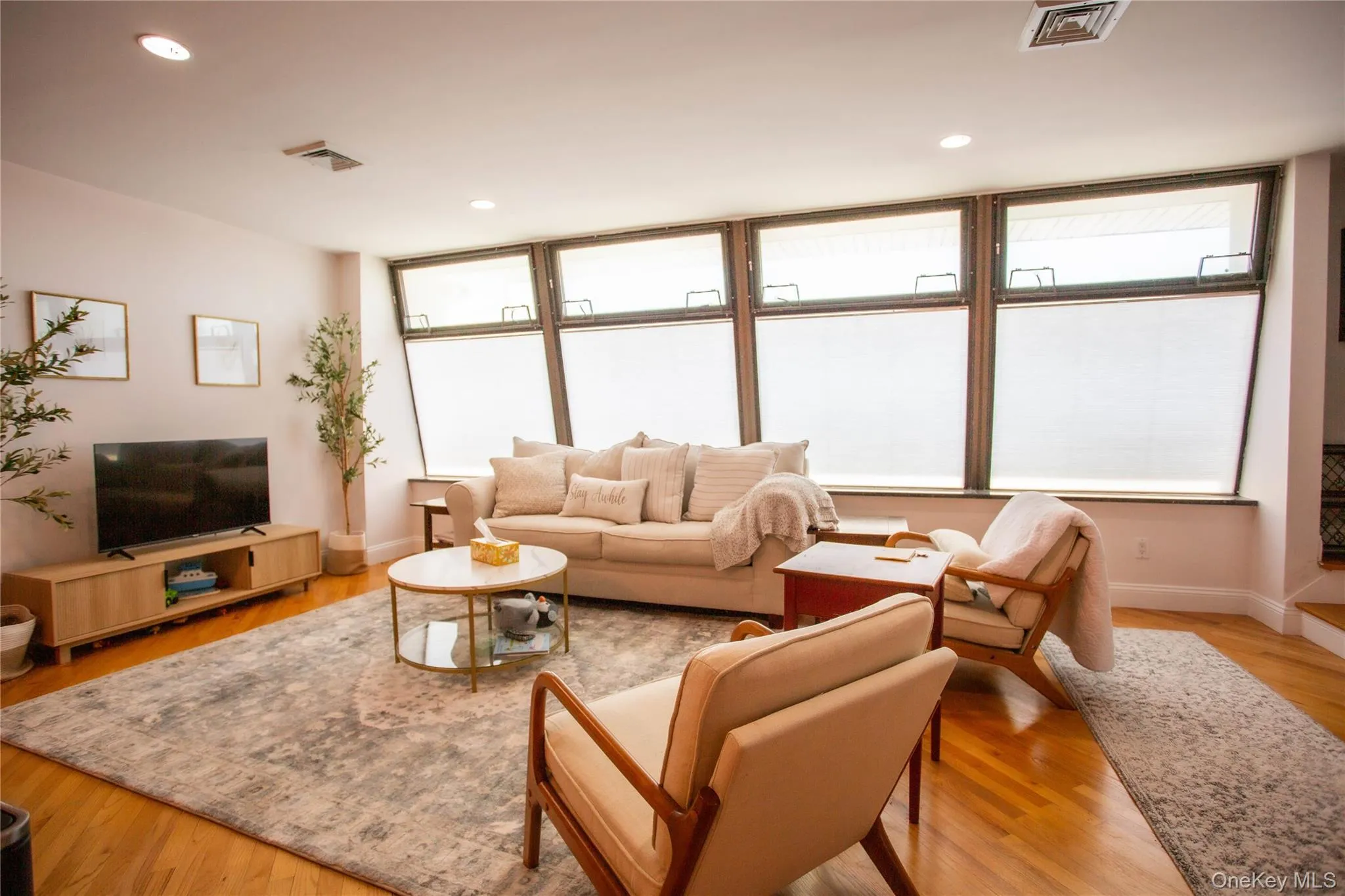 Living room featuring light wood finished floors and recessed lighting Living room featuring light wood finished floors and recessed lighting