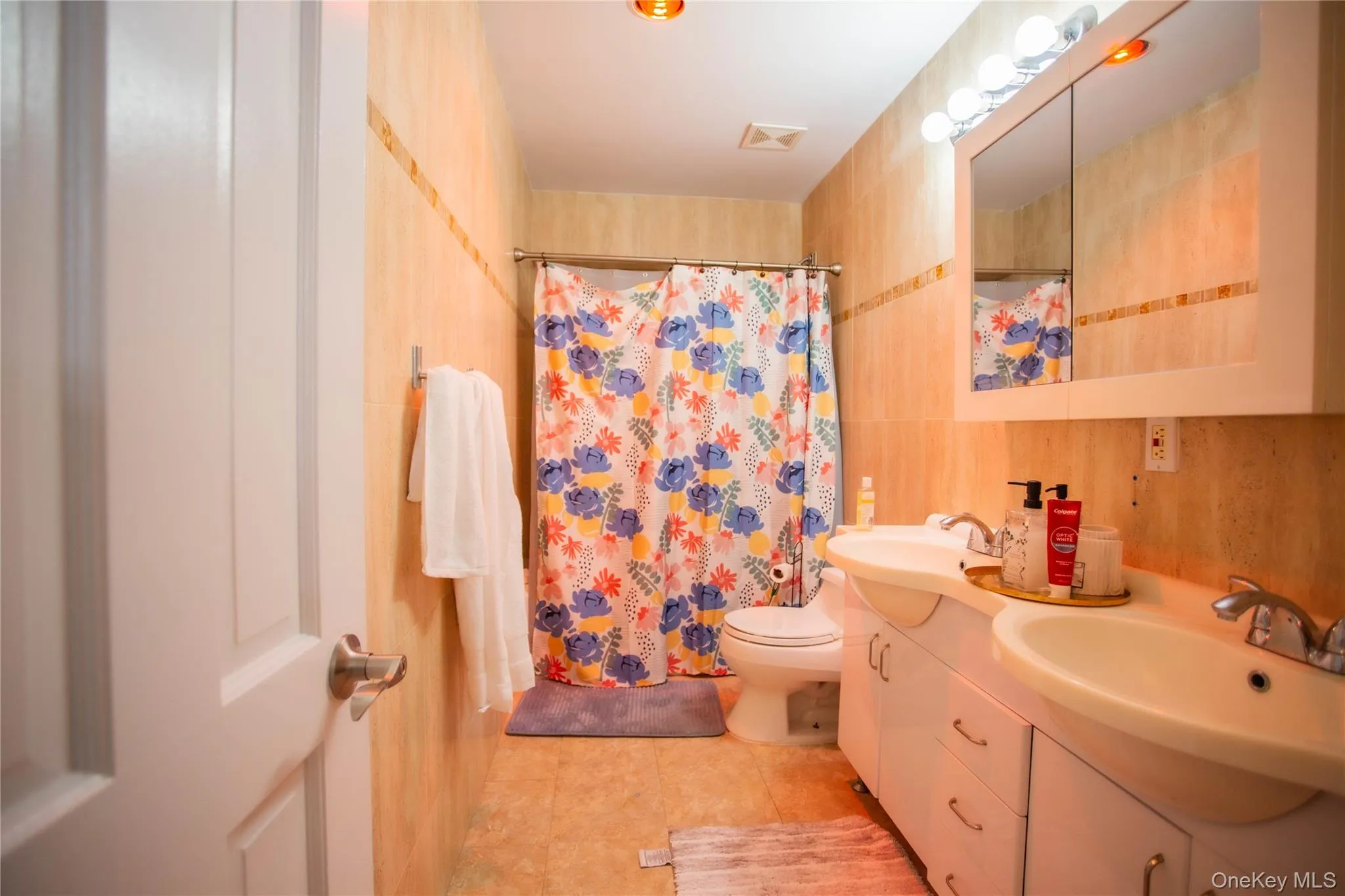 Full bath with double vanity and light tile patterned flooring Full bath with double vanity and light tile patterned flooring