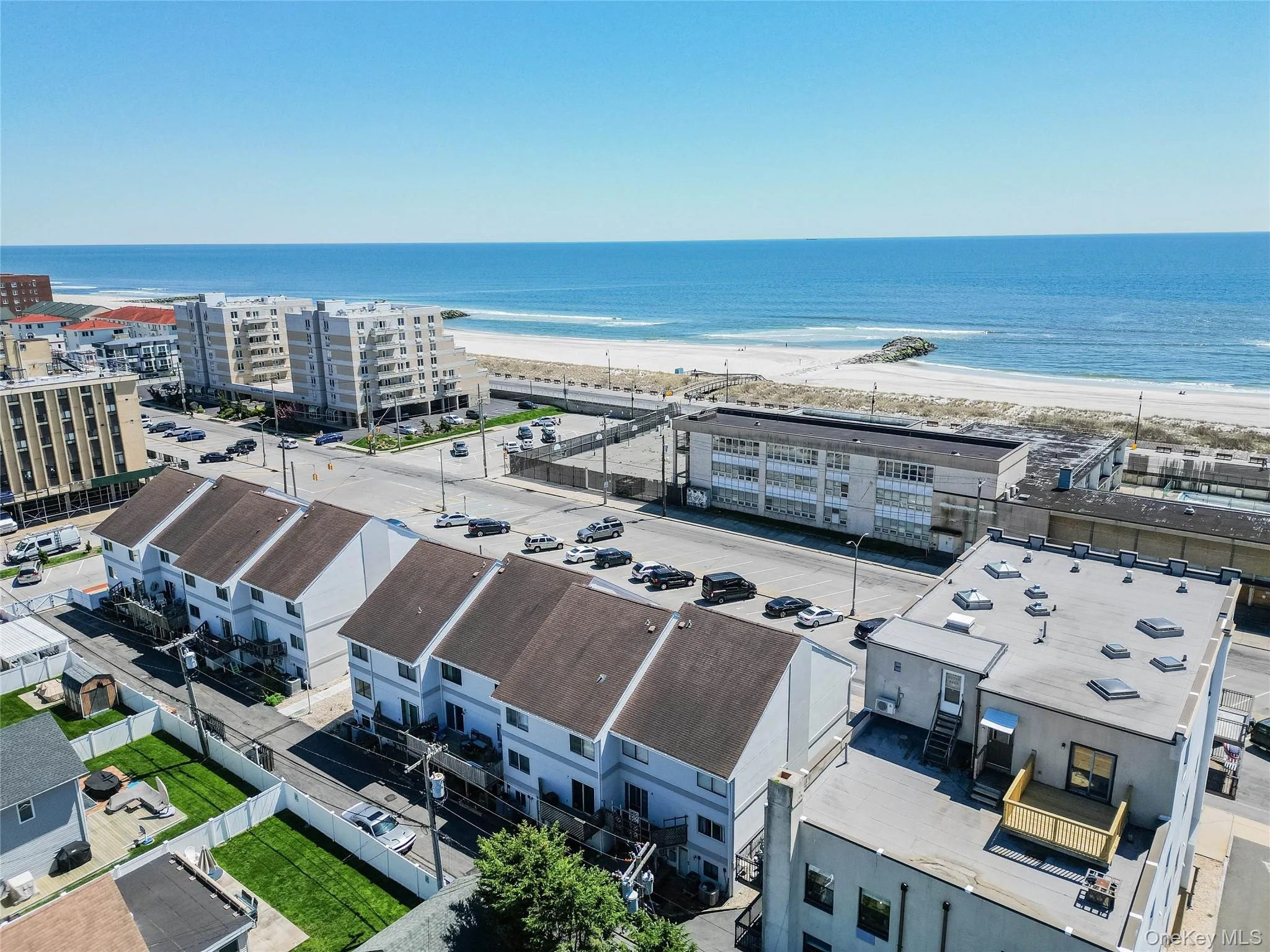 Bird's eye view of extended coastline and apartment complex Bird's eye view of extended coastline and apartment complex