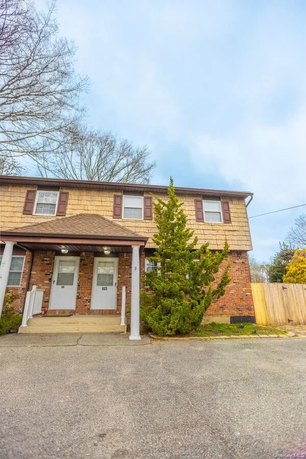 View of front facade with covered porch and brick siding View of front facade with covered porch and brick siding