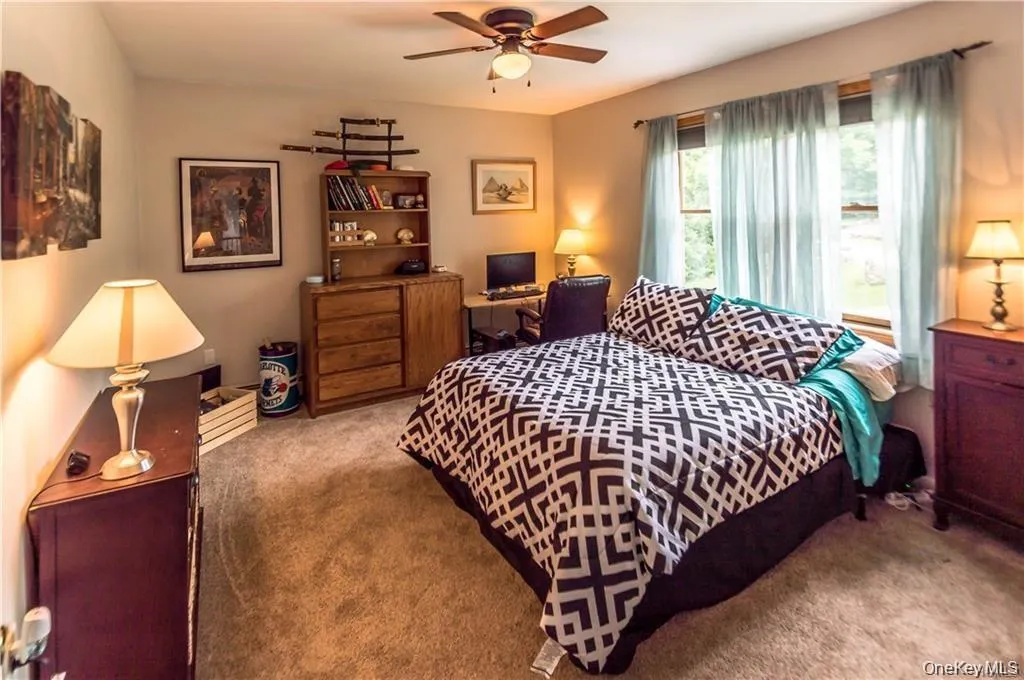 Bedroom featuring carpet and ceiling fan Bedroom featuring carpet and ceiling fan