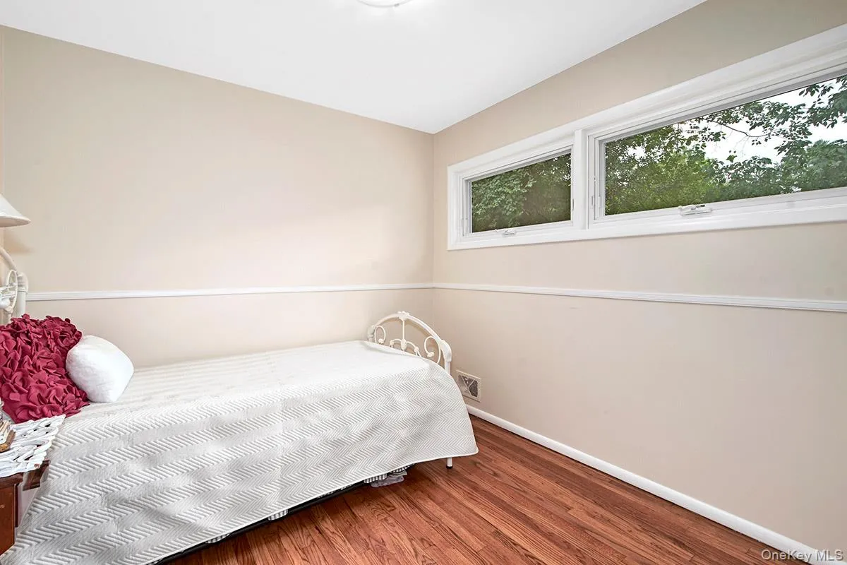 Bedroom with wood finished floors and baseboards Bedroom with wood finished floors and baseboards