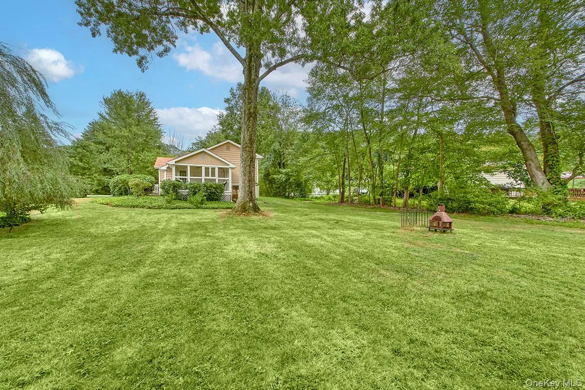 View of grassy yard with a sunroom View of grassy yard with a sunroom