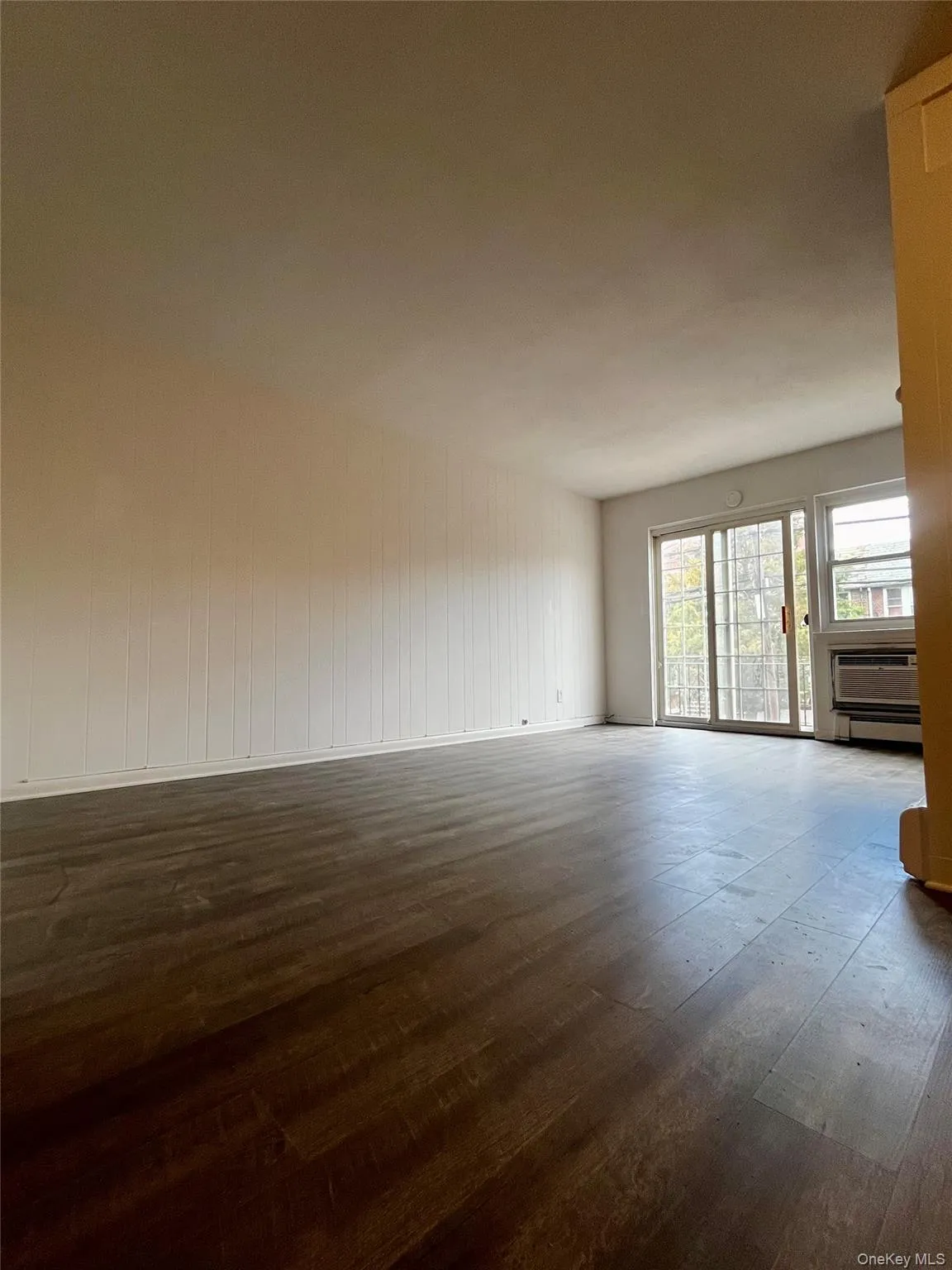 Unfurnished room featuring dark wood-style flooring Unfurnished room featuring dark wood-style flooring