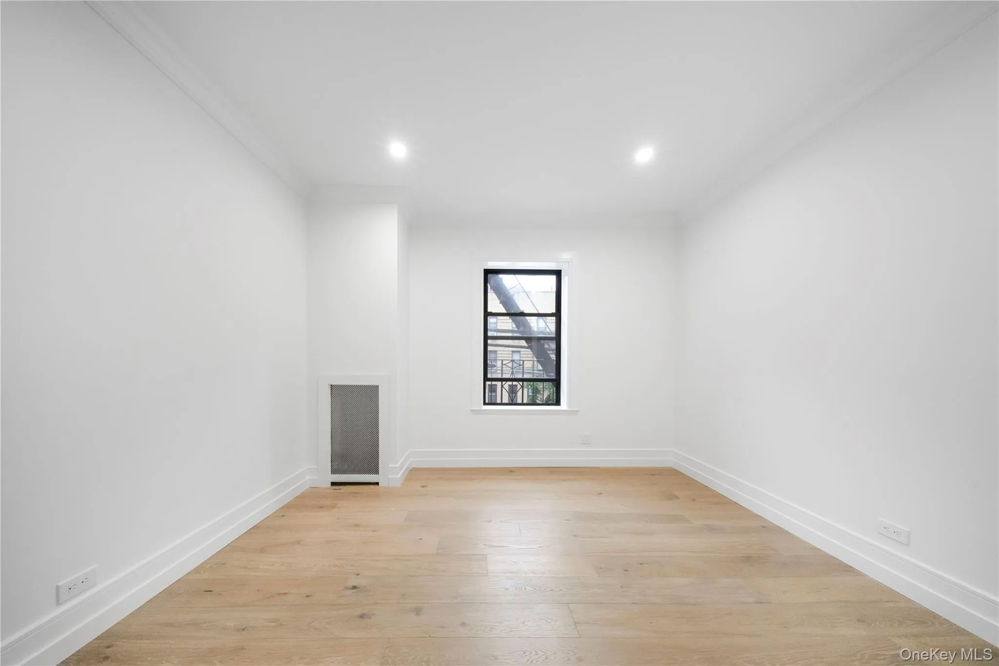 Spare room featuring ornamental molding, light wood-style floors, and recessed lighting Spare room featuring ornamental molding, light wood-style floors, and recessed lighting