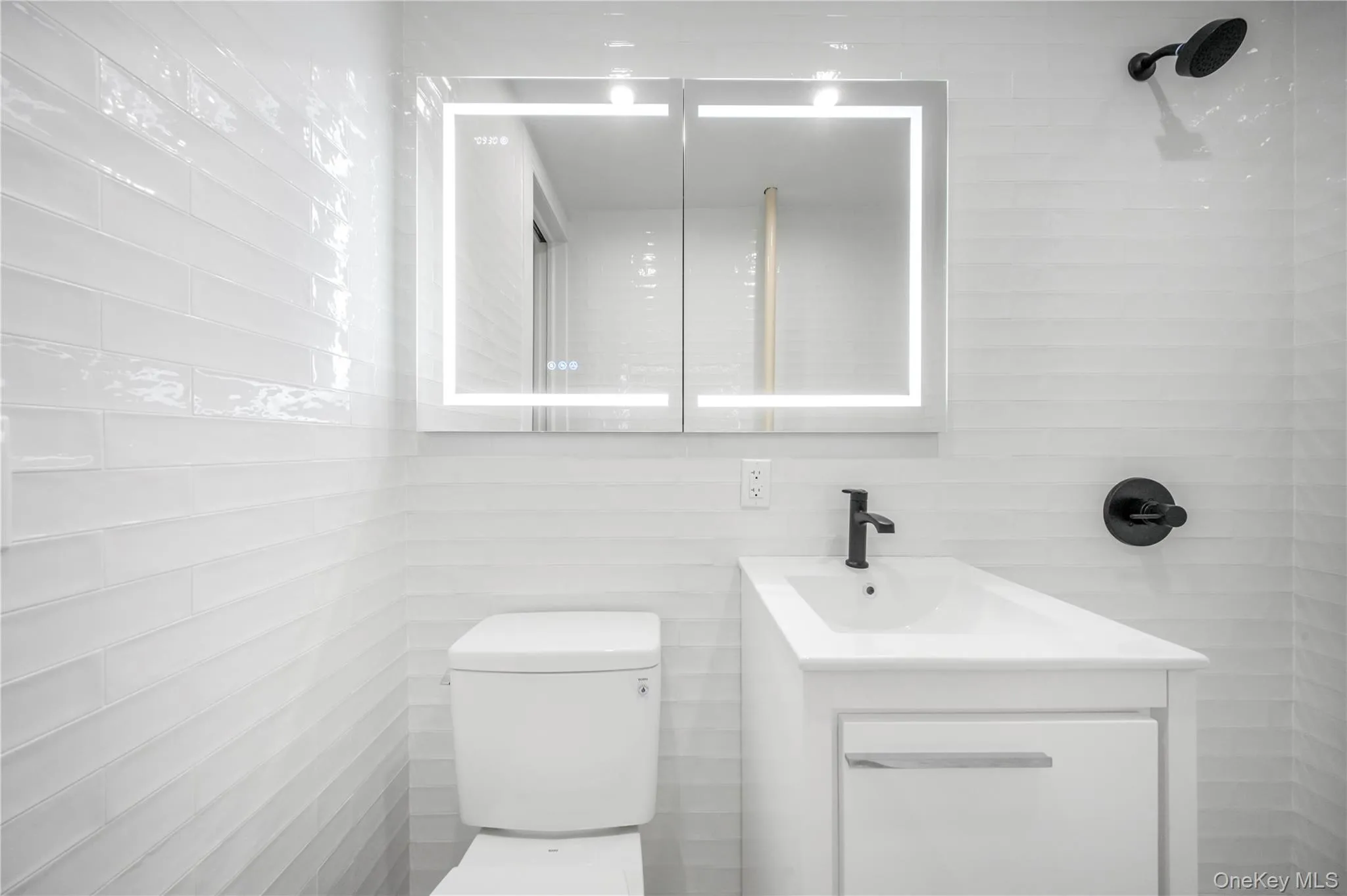 Bathroom with vanity and tile walls Bathroom with vanity and tile walls