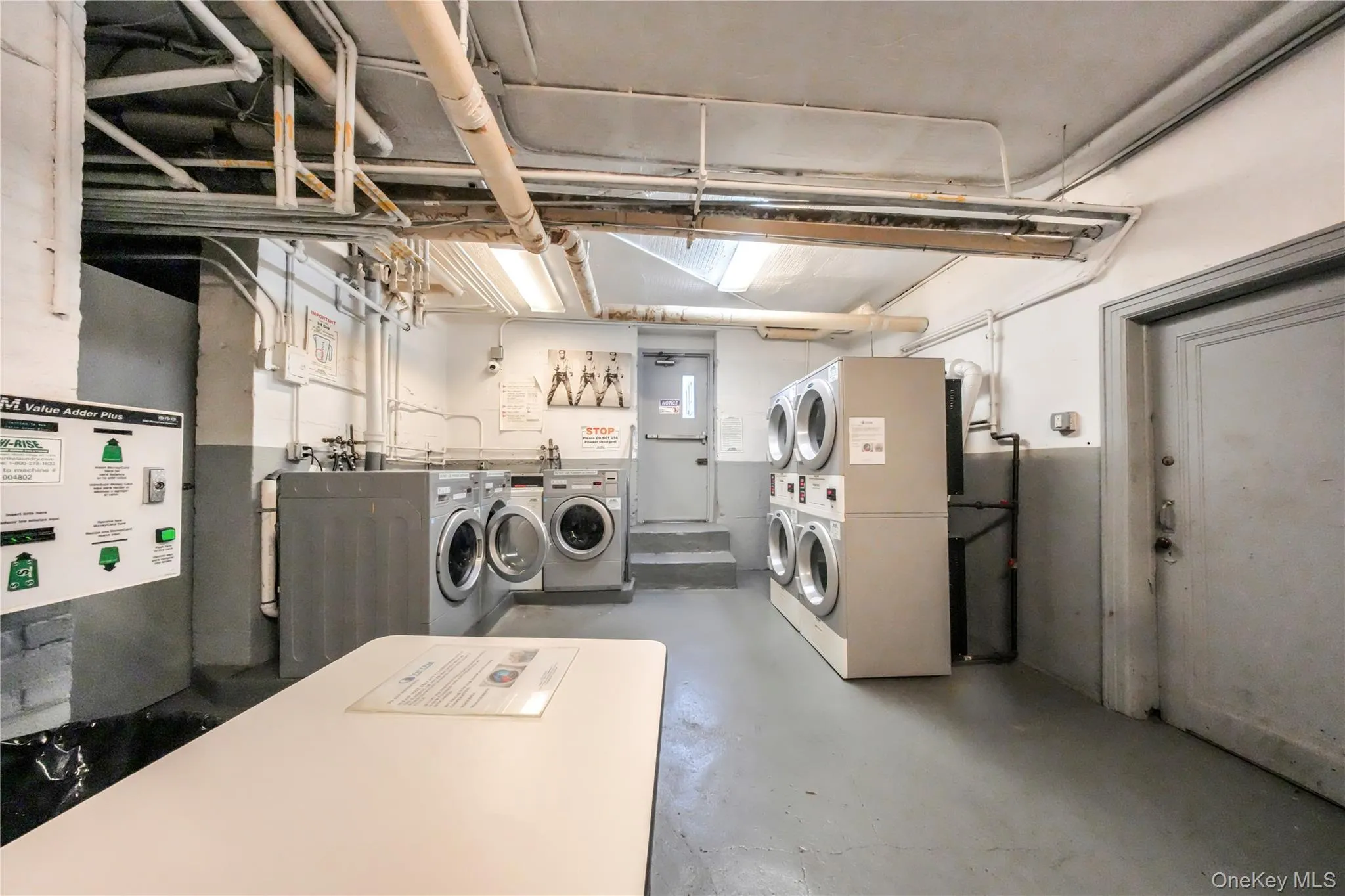 Shared laundry room with stacked washer / dryer and separate washer and dryer Shared laundry room with stacked washer / dryer and separate washer and dryer