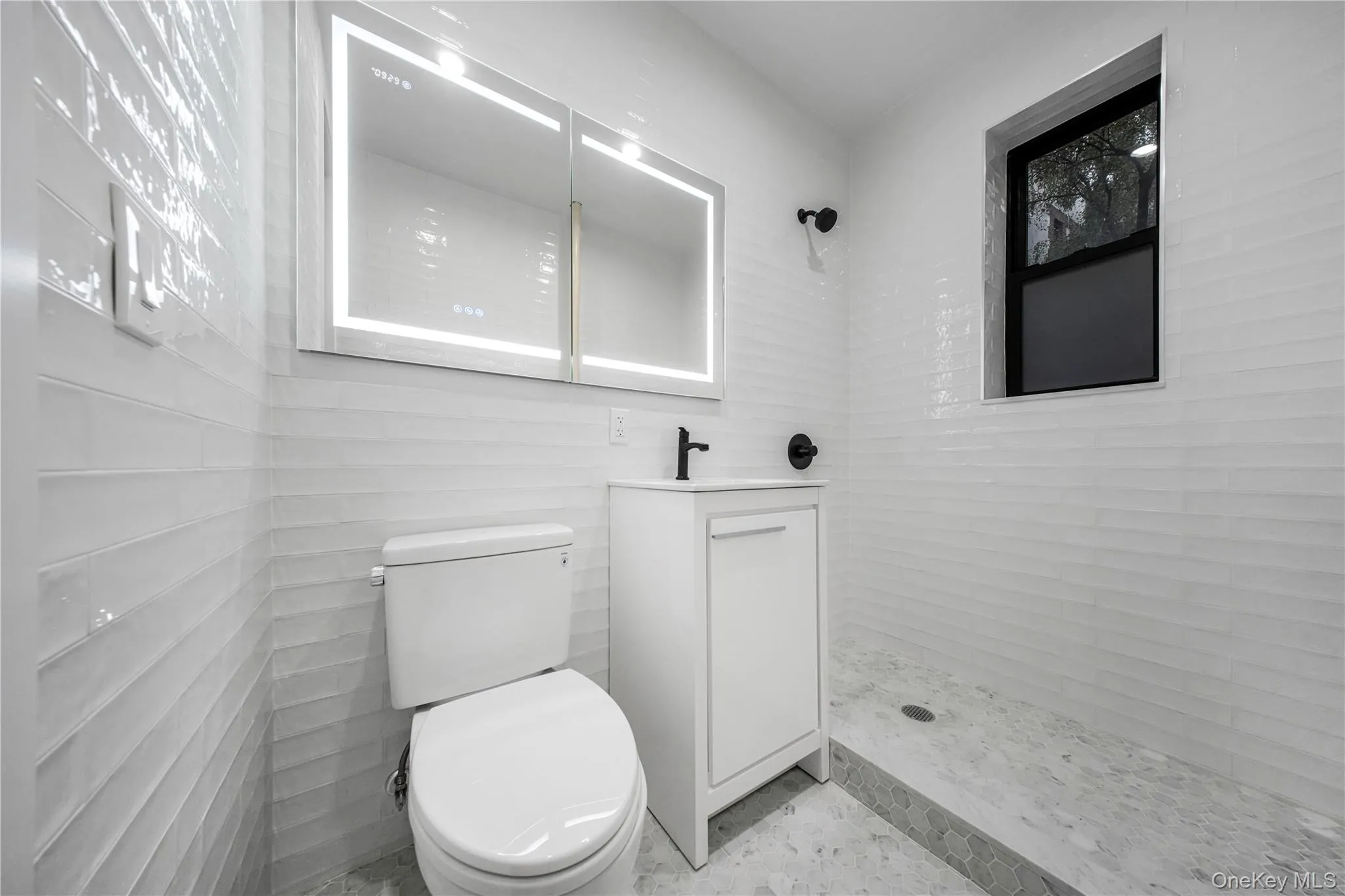 Bathroom featuring a stall shower and vanity Bathroom featuring a stall shower and vanity