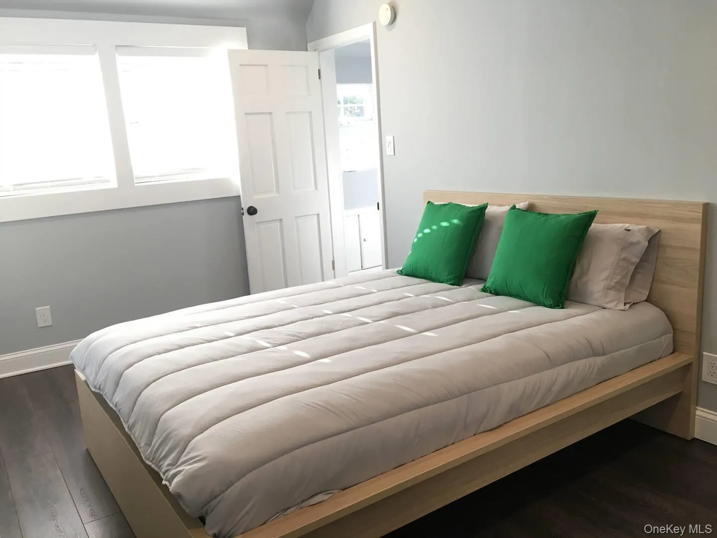 Bedroom with dark wood-style flooring Bedroom with dark wood-style flooring