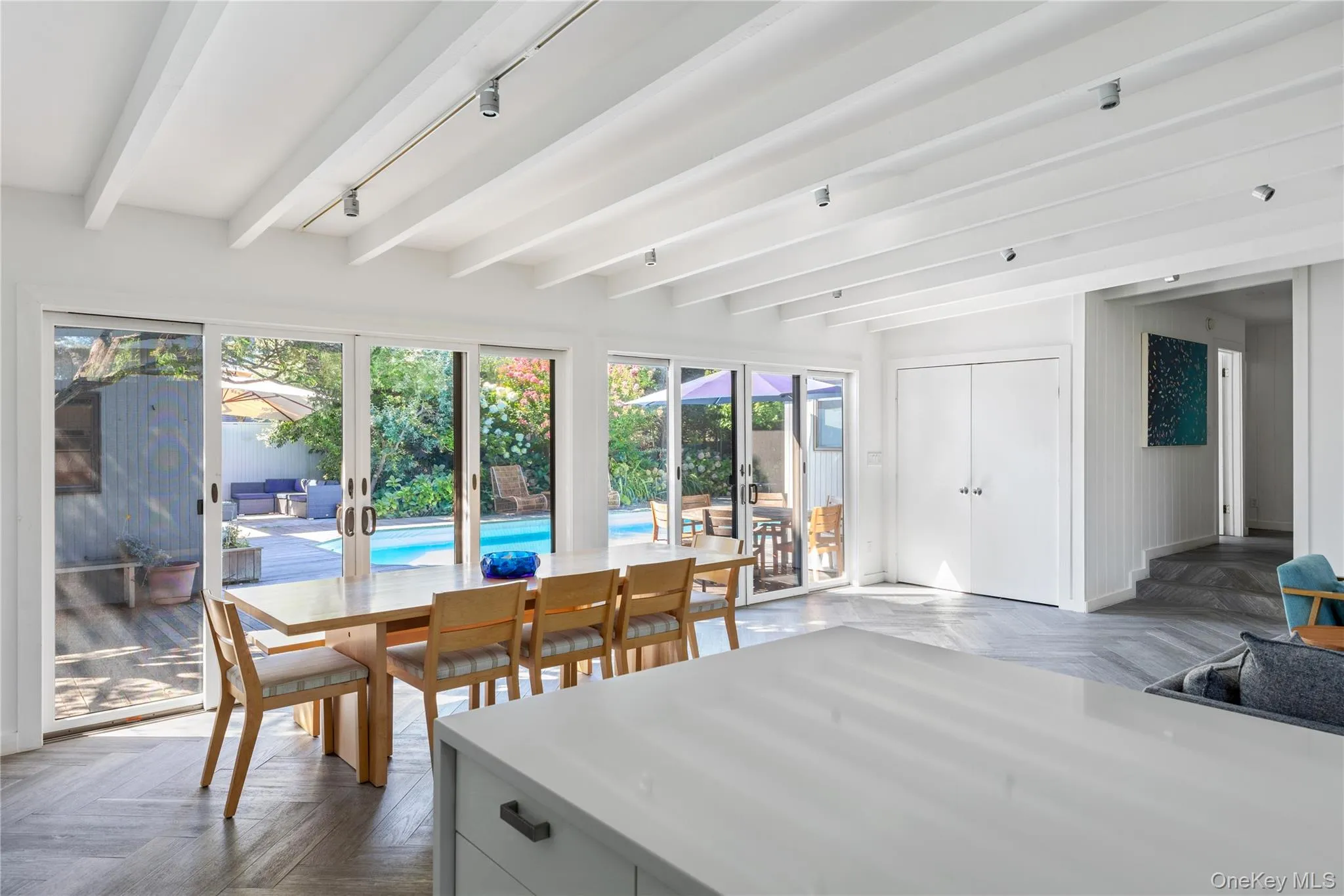 Sunroom with beamed ceiling and rail lighting Sunroom with beamed ceiling and rail lighting