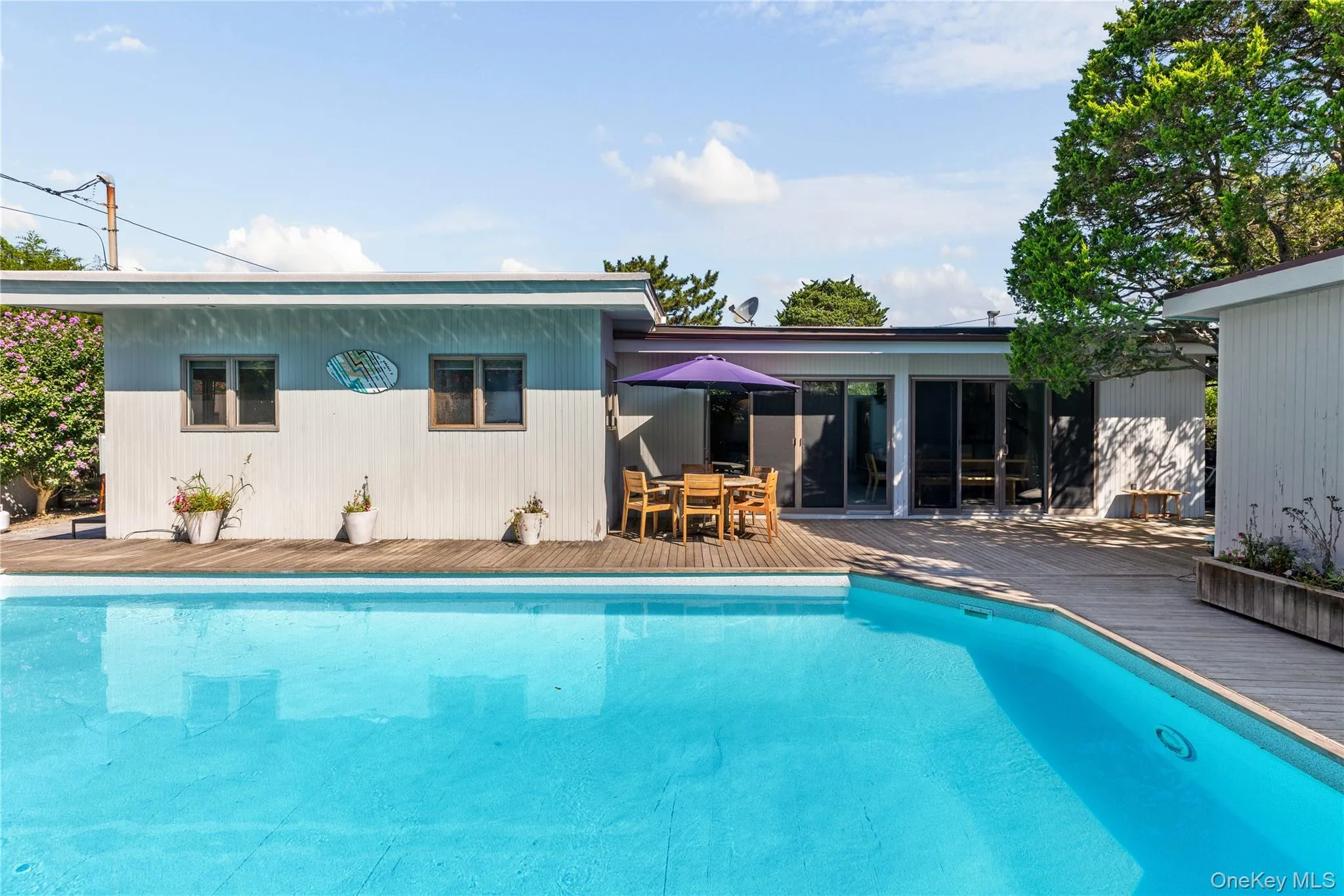 Outdoor pool with a deck and outdoor dining area Outdoor pool with a deck and outdoor dining area