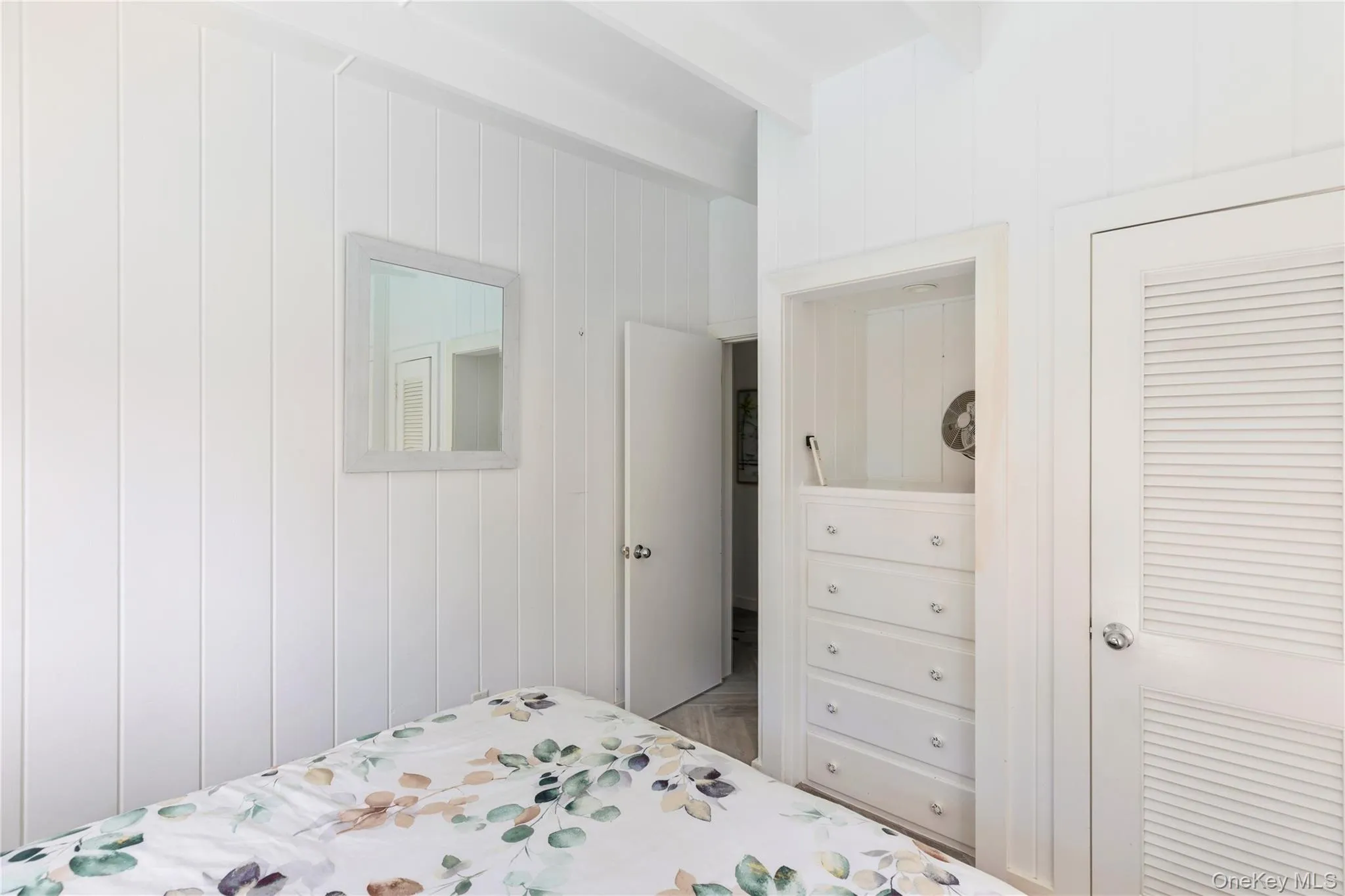 Bedroom with beam ceiling and wooden walls Bedroom with beam ceiling and wooden walls