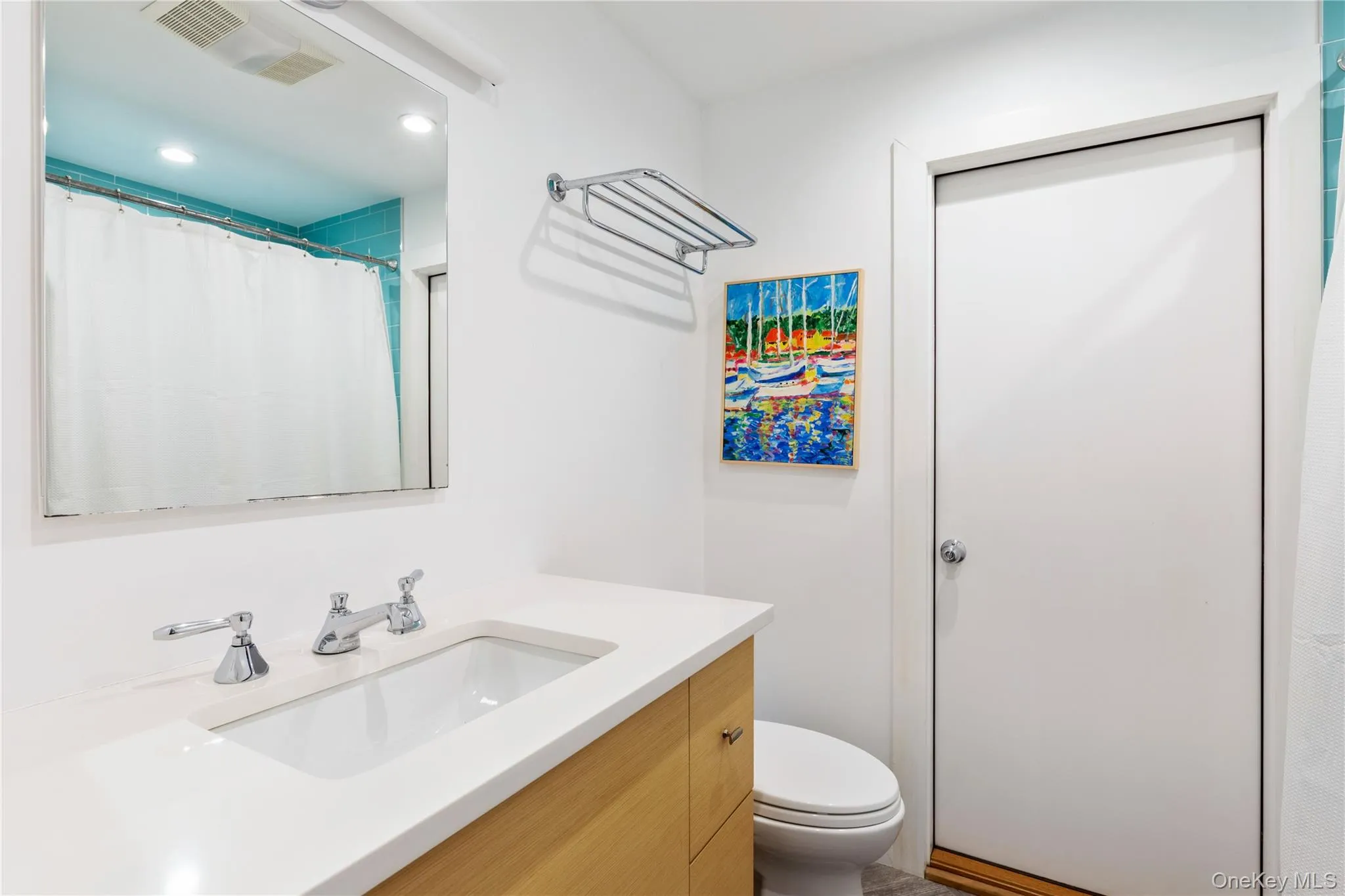 Bathroom featuring vanity, recessed lighting, and curtained shower Bathroom featuring vanity, recessed lighting, and curtained shower