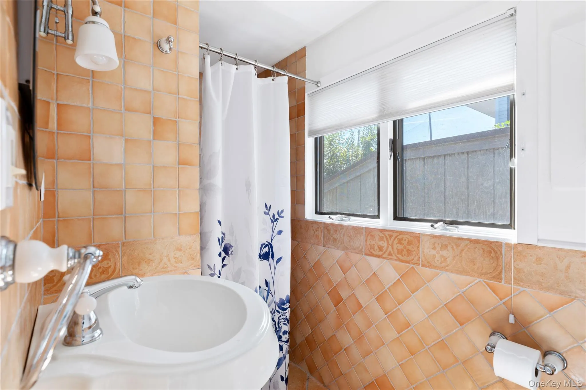 Bathroom featuring tile walls and a sink Bathroom featuring tile walls and a sink