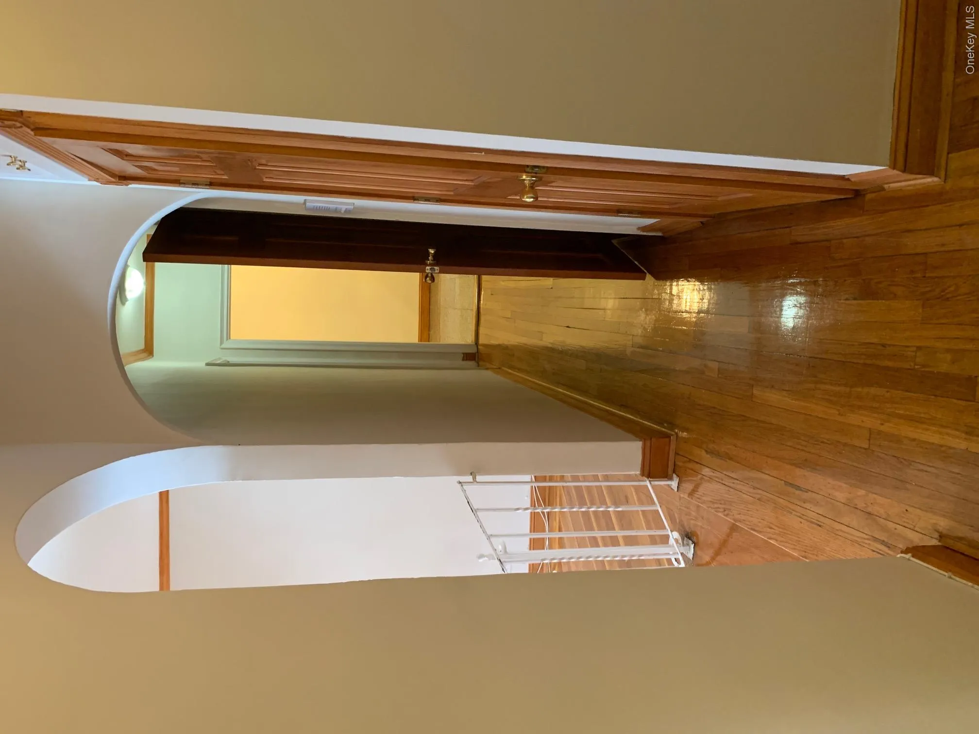 Corridor with hardwood / wood-style flooring and arched walkways Corridor with hardwood / wood-style flooring and arched walkways