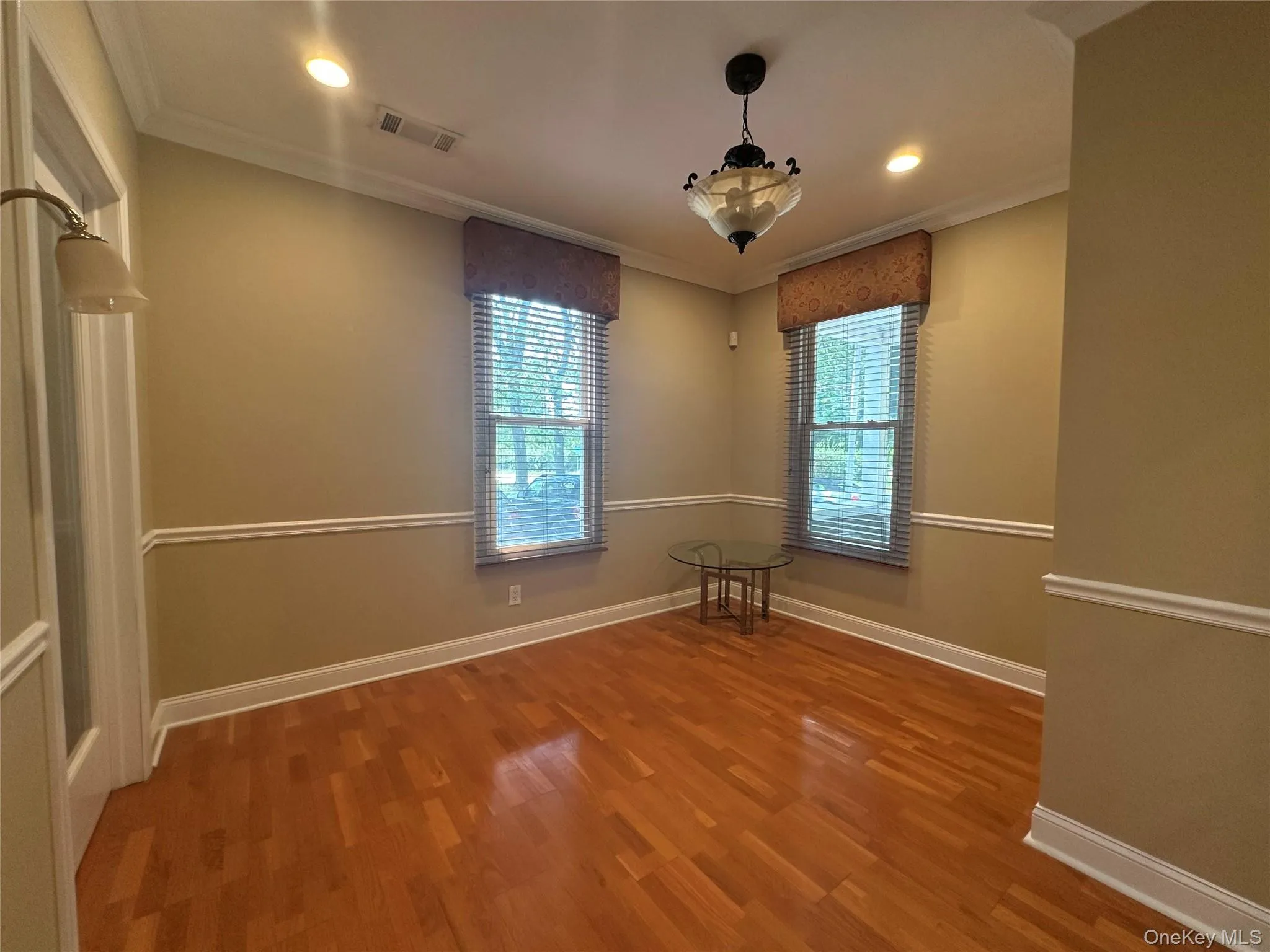 crown molding, wood finished floors, and recessed lighting crown molding, wood finished floors, and recessed lighting