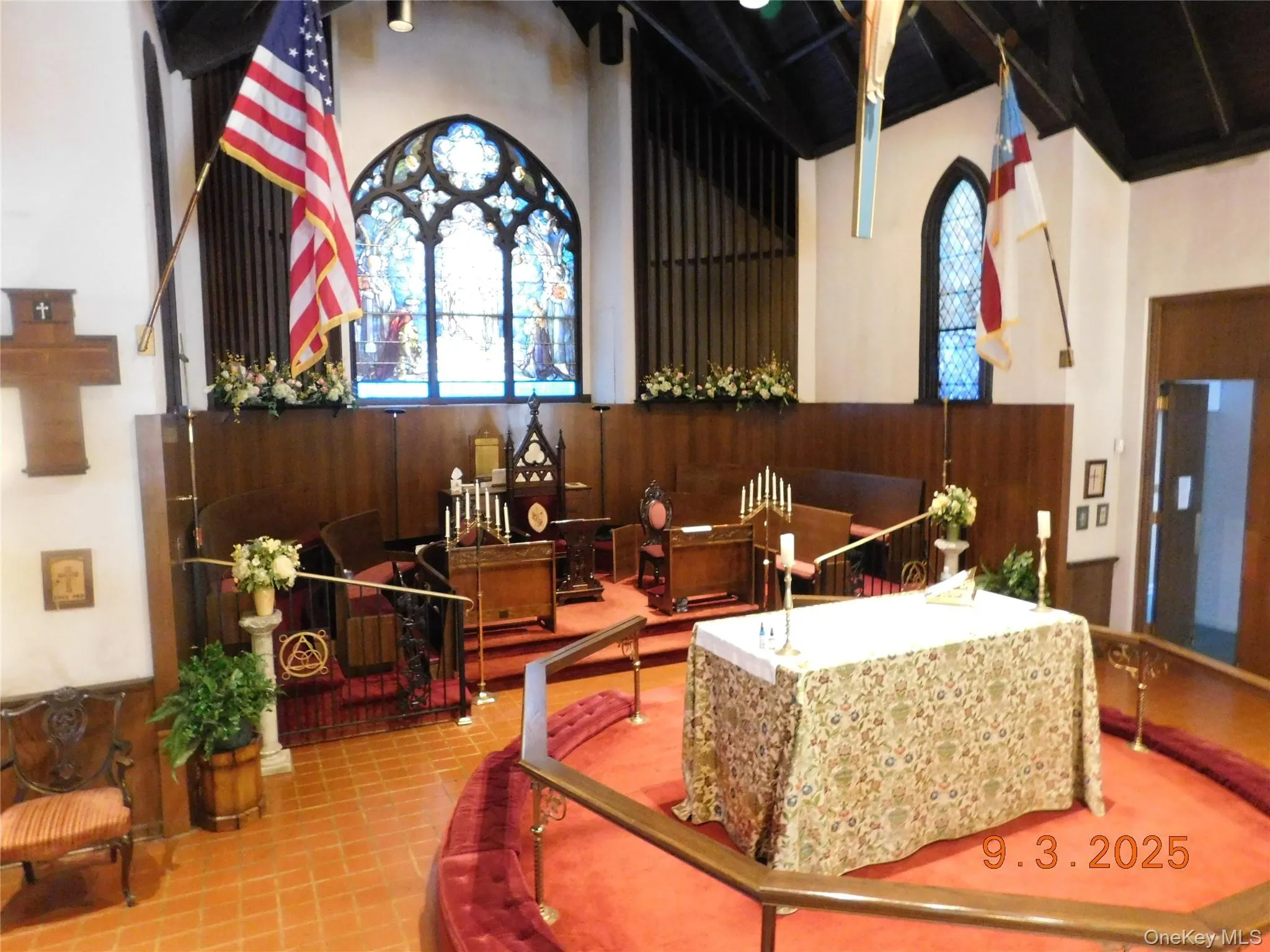Common area with wooden walls, wainscoting, and a high ceiling Common area with wooden walls, wainscoting, and a high ceiling
