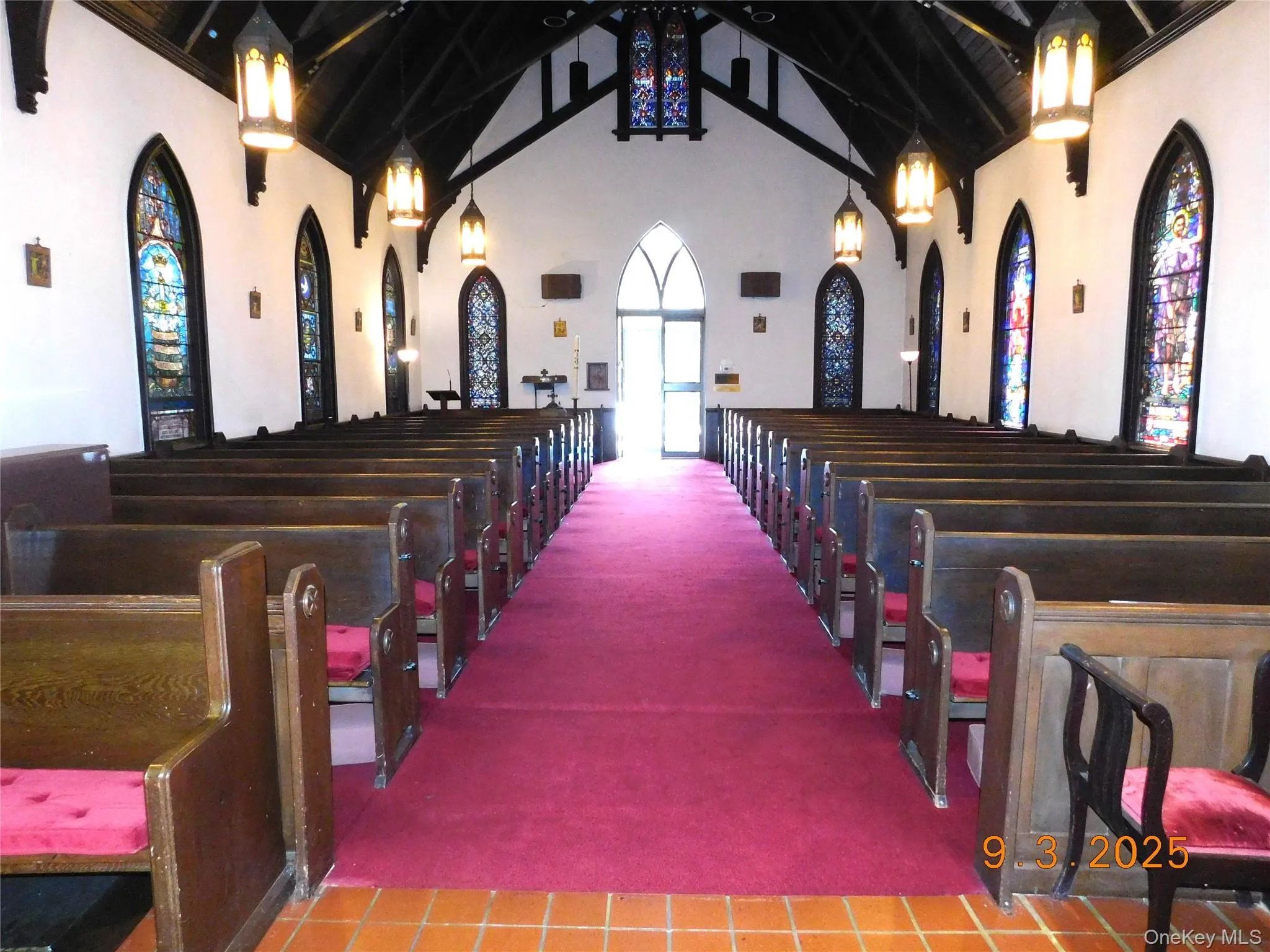 Misc room with carpet, high vaulted ceiling, beam ceiling, and stairway Misc room with carpet, high vaulted ceiling, beam ceiling, and stairway