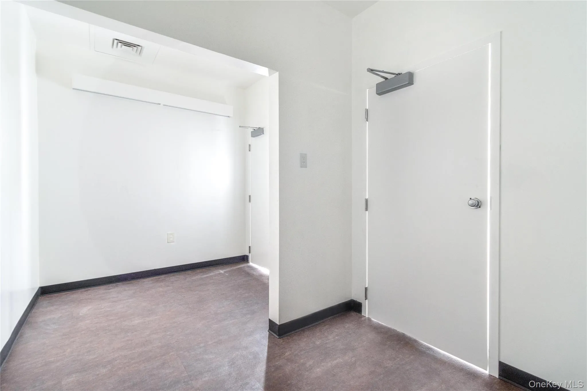 Unfurnished room with baseboards Unfurnished room with baseboards