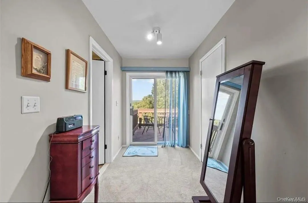 Entryway featuring carpet flooring and baseboards Entryway featuring carpet flooring and baseboards