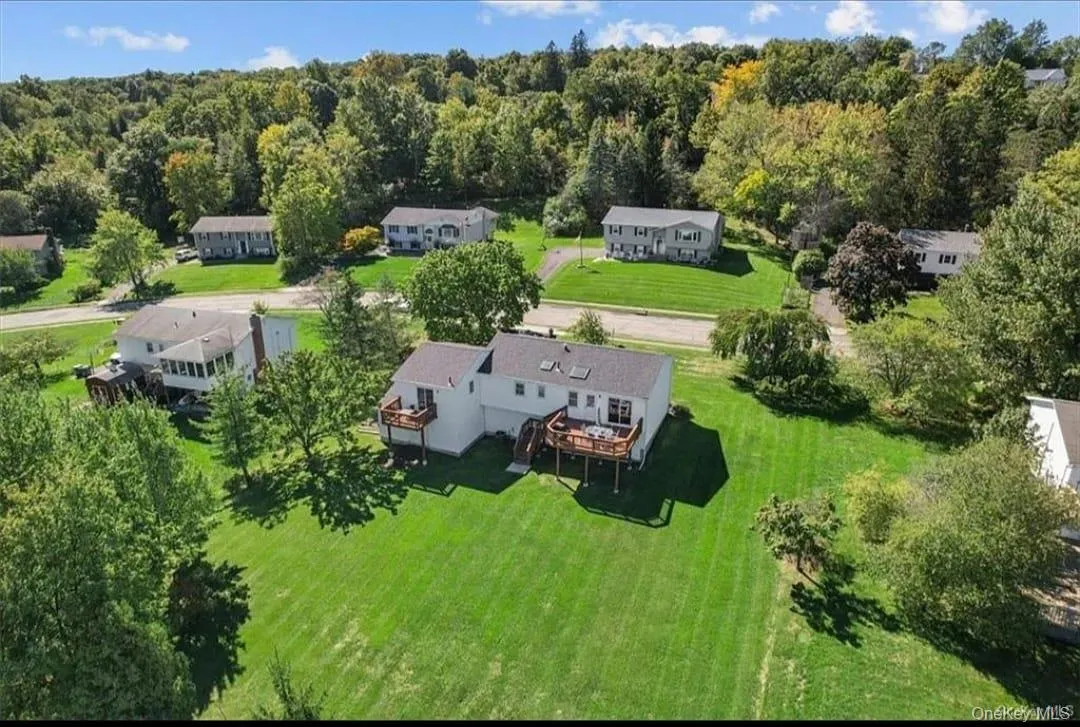 Aerial view of property and surrounding area with a heavily wooded area Aerial view of property and surrounding area with a heavily wooded area