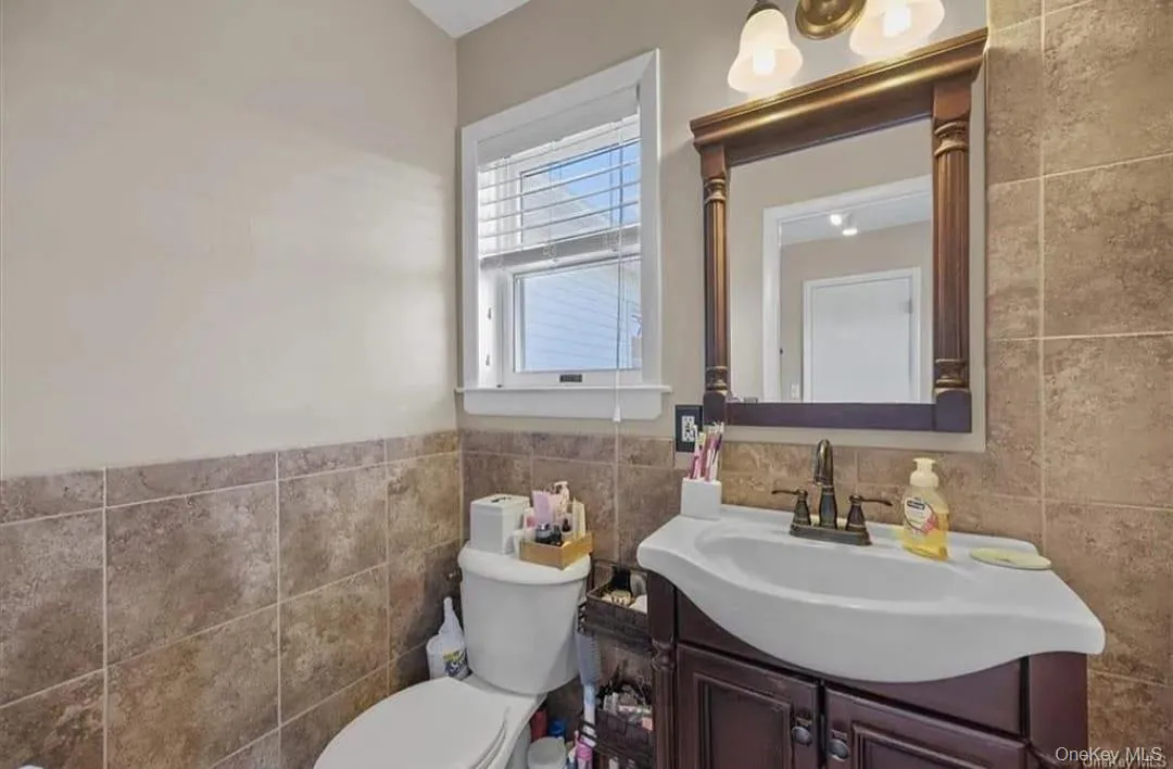Half bath with tile walls and vanity Half bath with tile walls and vanity